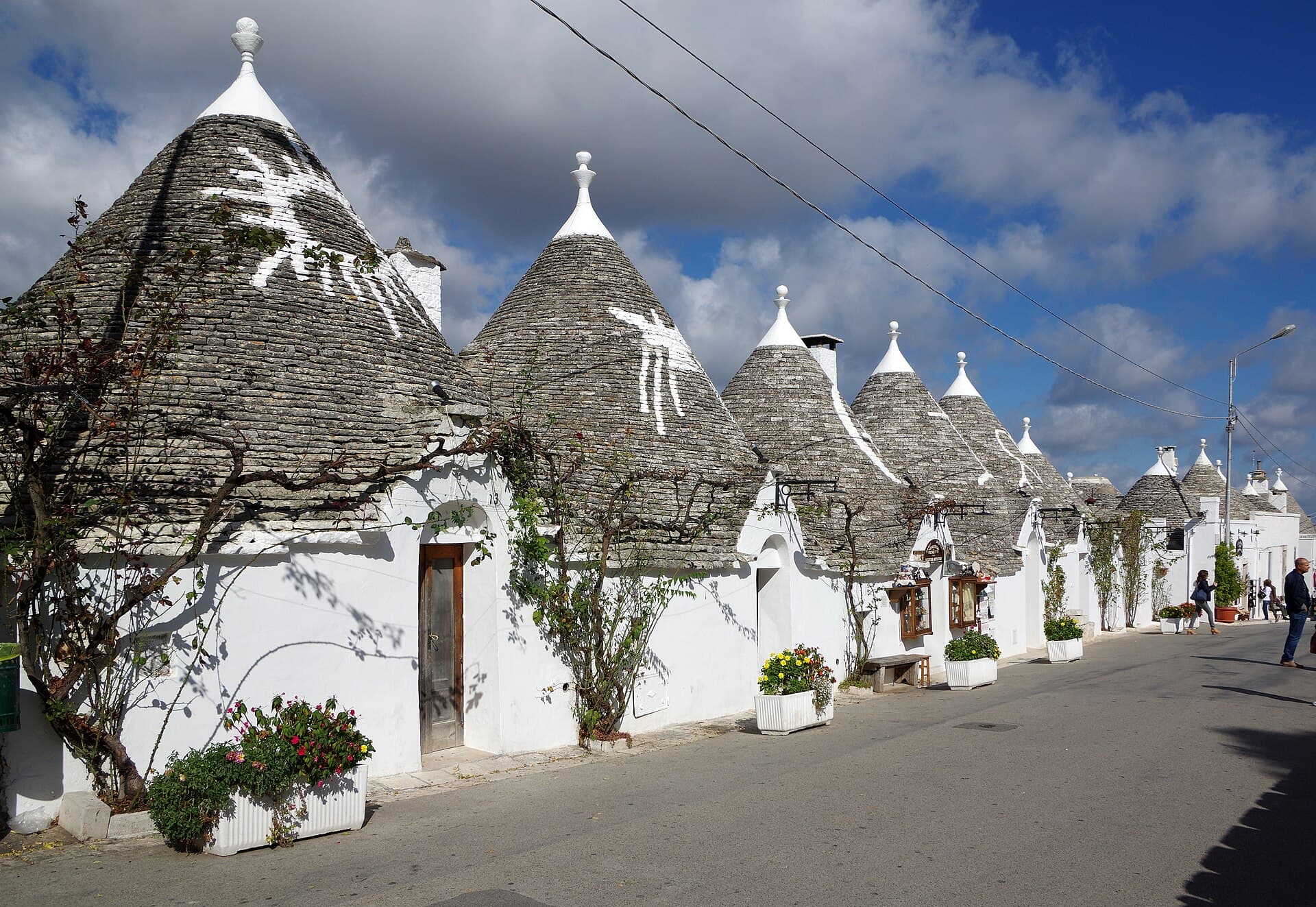 A street of whitewashed trulli with conical stone roofs in Alberobello