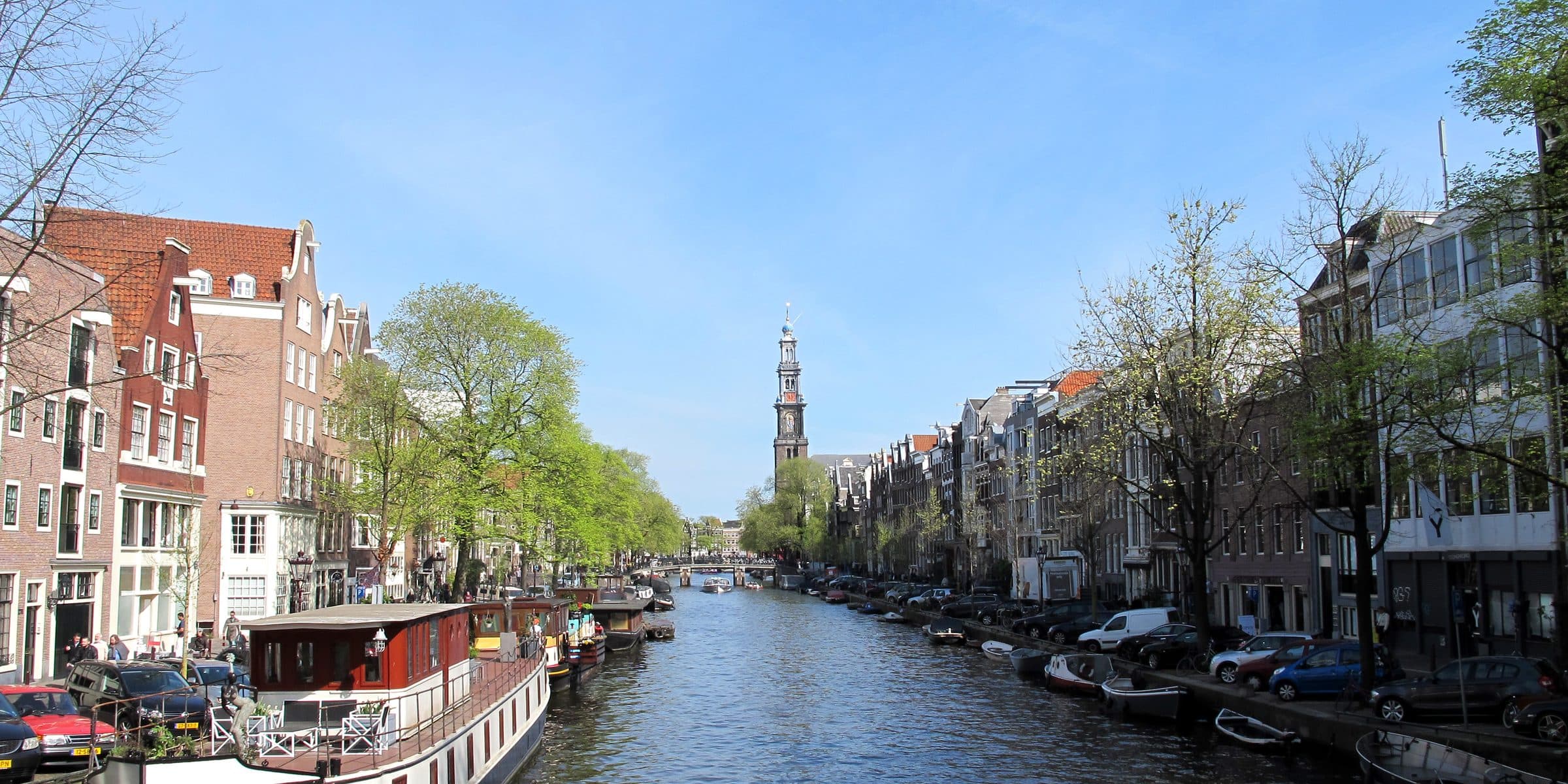 Houseboats and gabled canal houses along an Amsterdam canal