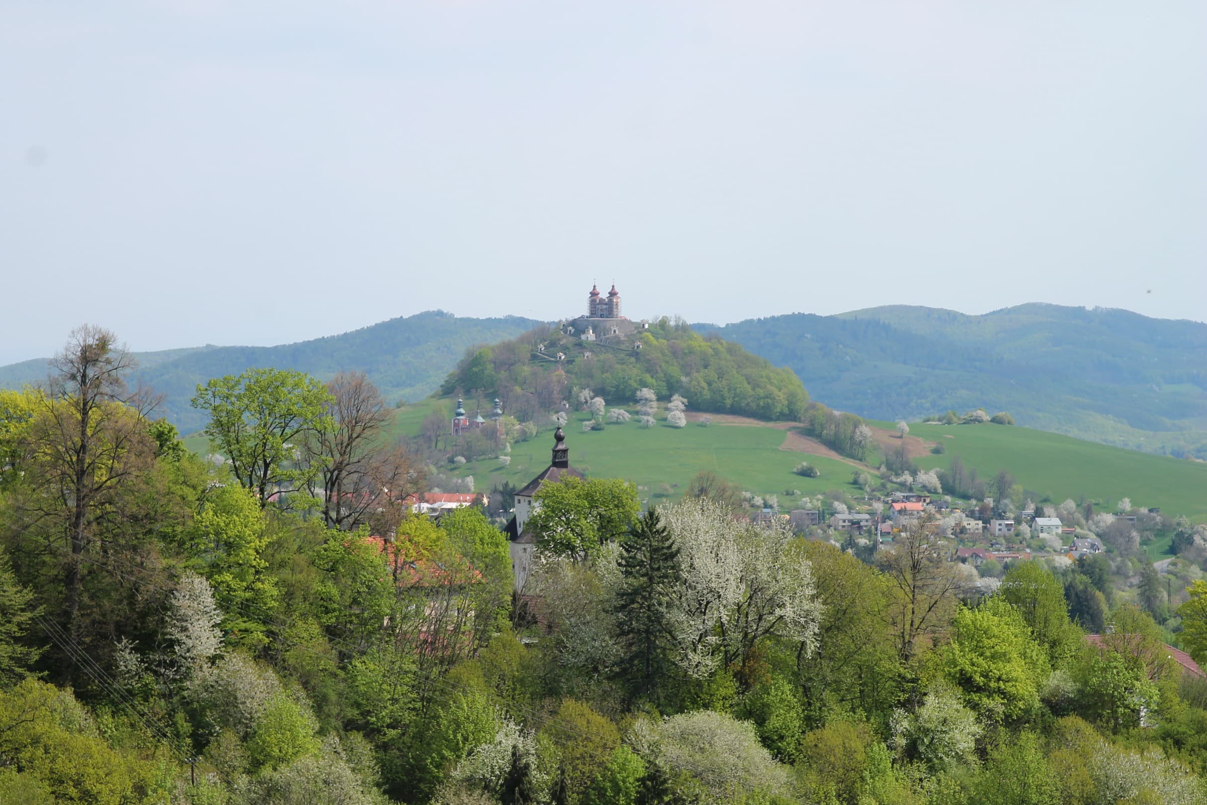 Panoramic elevated view of historic Banská Štiavnica with its church spires and town houses tucked in the volcanic caldera