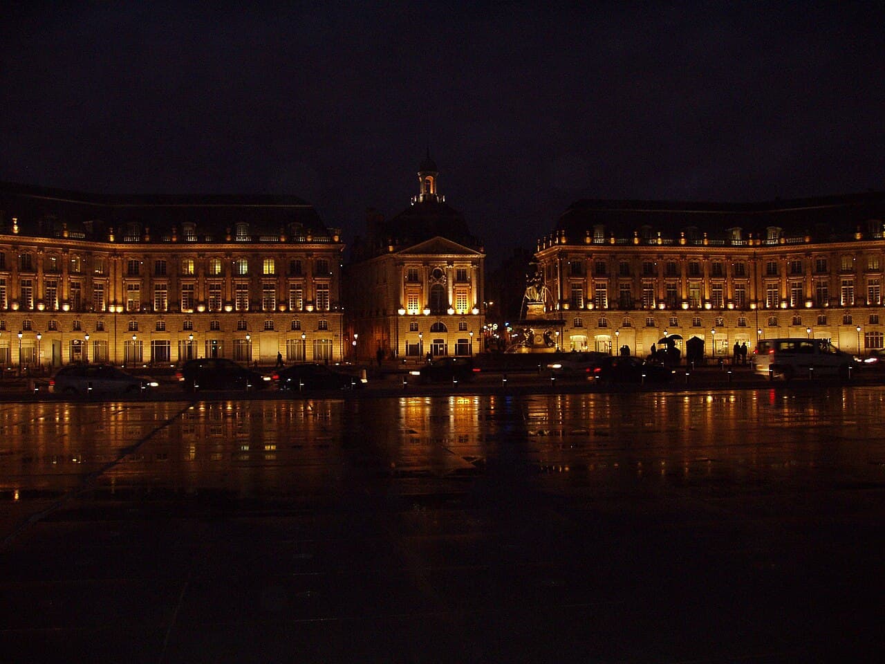 Place de la Bourse and its water mirror reflecting lights in Bordeaux
