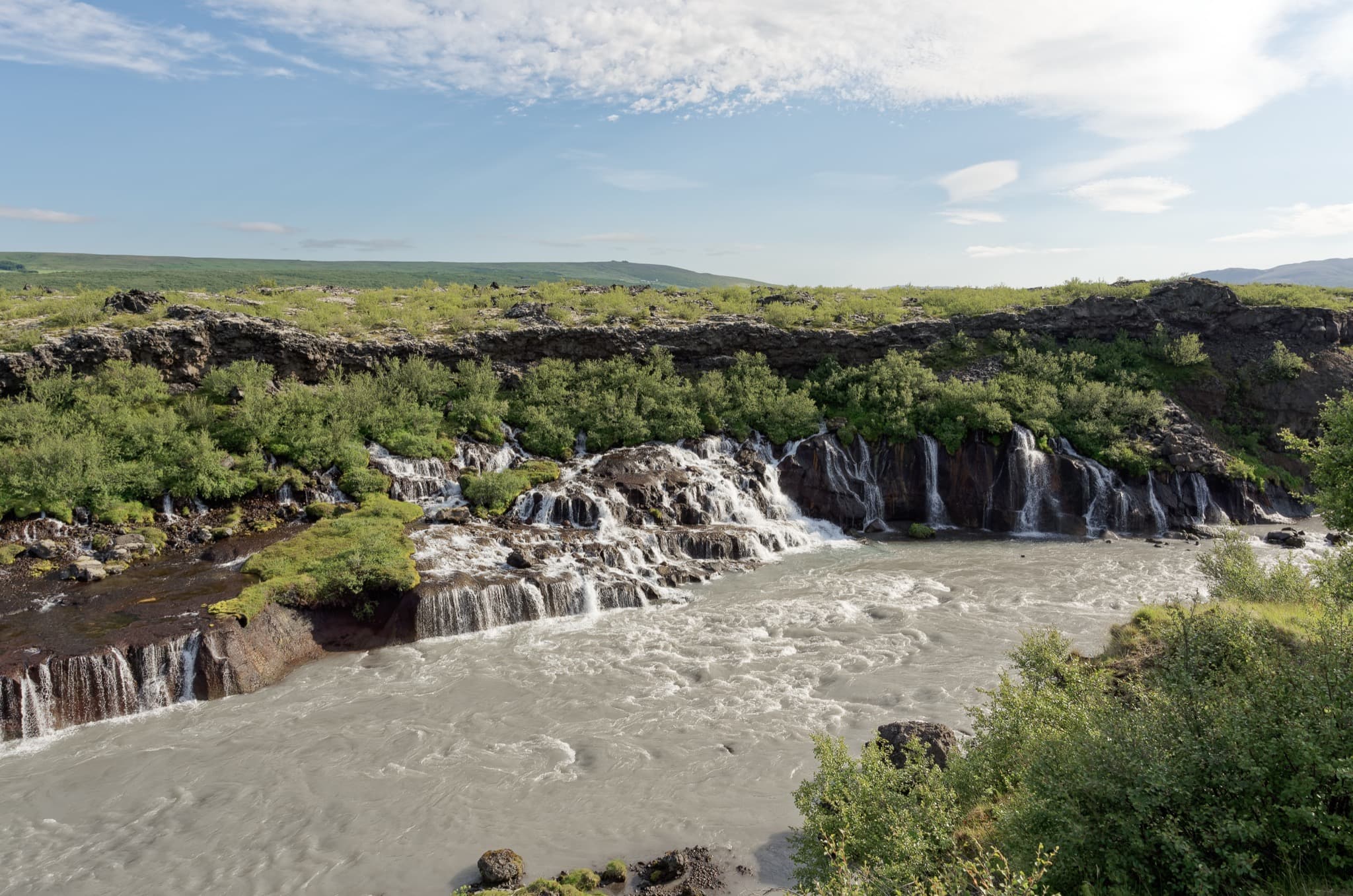 Hraunfossar series of clear glacial springs cascading out of the Hallmundarhraun lava field
