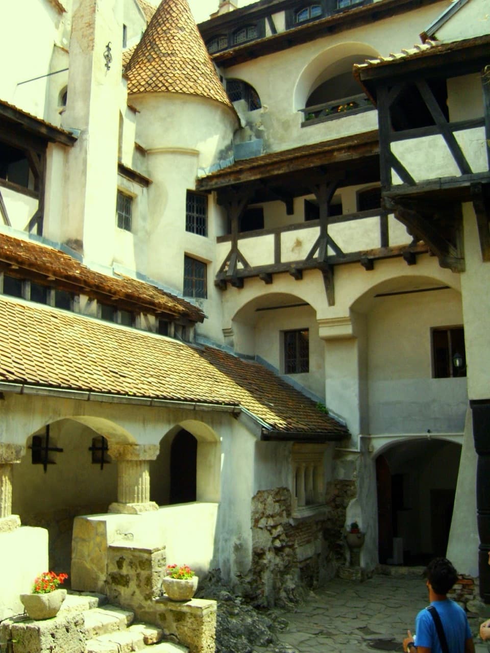 Bran Castle perched dramatically atop a rocky cliff guarding the mountain pass between Transylvania and Wallachia