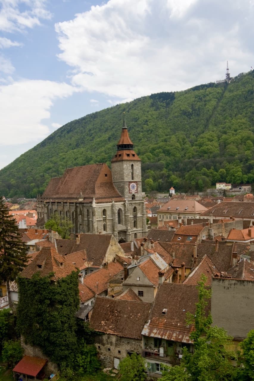 Panoramic view of Brașov Old Town square and the massive stone Black Church framed by Mount Tâmpa
