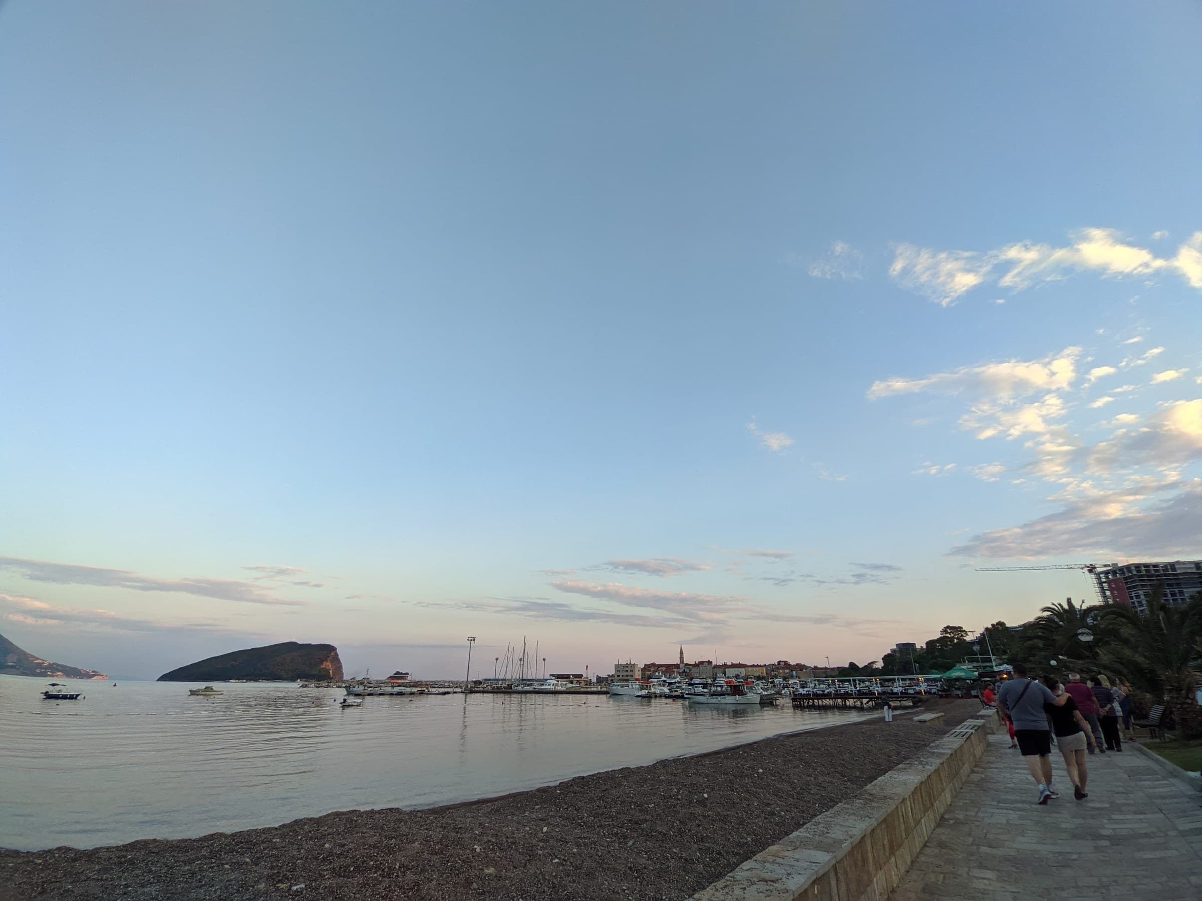 Medieval walled Old Town of Budva jutting out into azure Adriatic waters