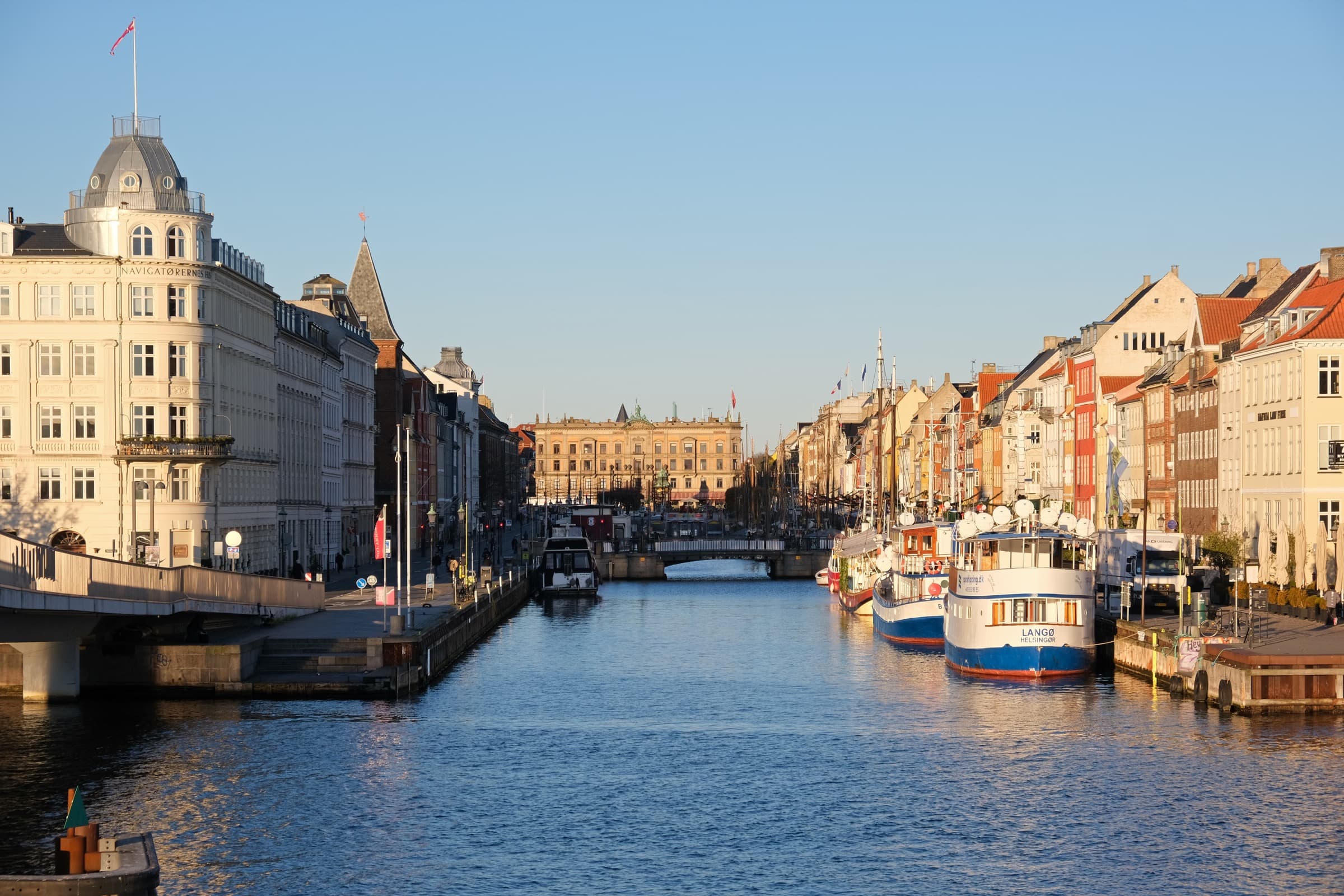 Coloured townhouses and moored boats along Nyhavn in Copenhagen
