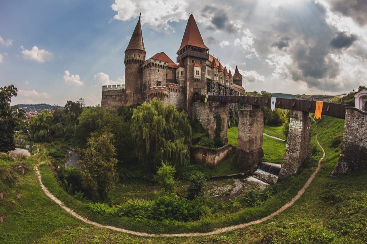 The soaring wooden drawbridge, stone towers and Gothic turrets of Corvin Castle in Hunedoara