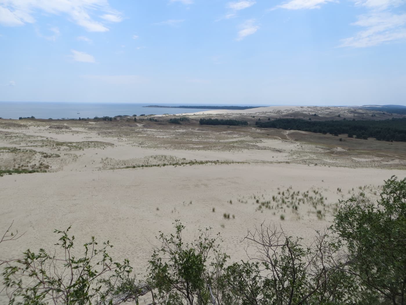 Sweeping white sand dunes and blue-trimmed wooden fishermen's cottages in Nida on the Curonian Spit