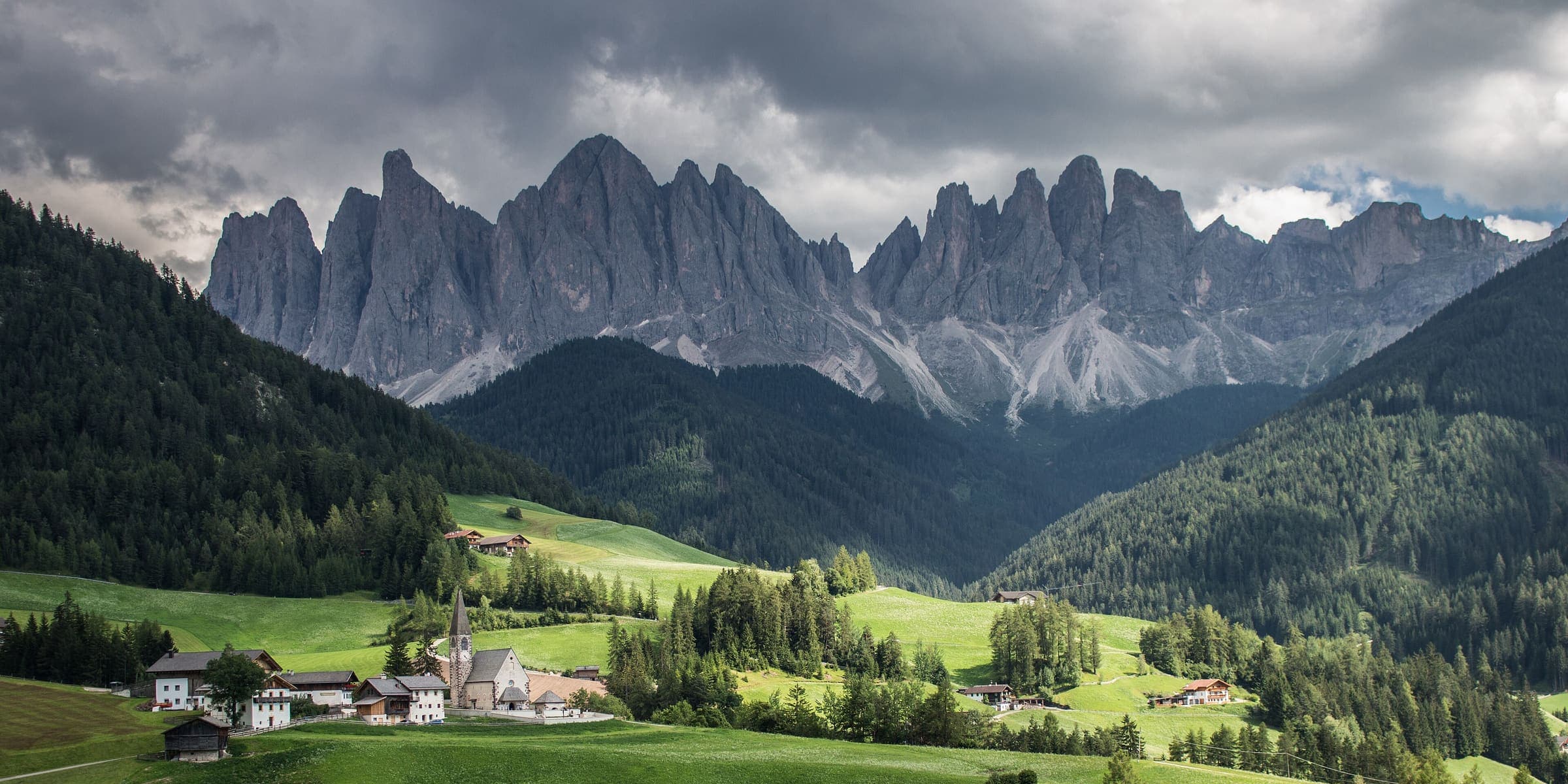The jagged Odle peaks above the meadows and church of Val di Funes