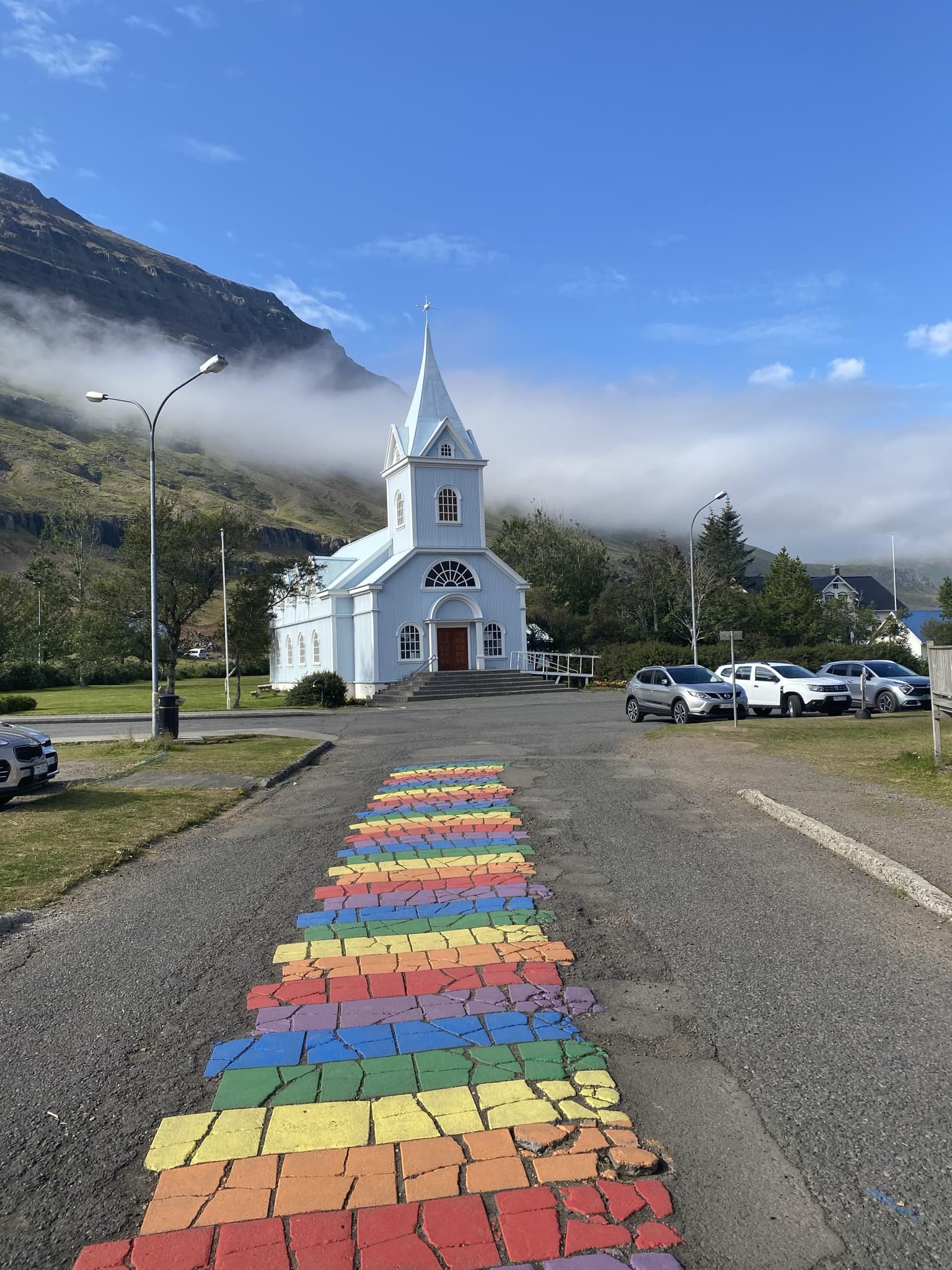 The powder-blue church and rainbow street of Seyðisfjörður in the Eastfjords