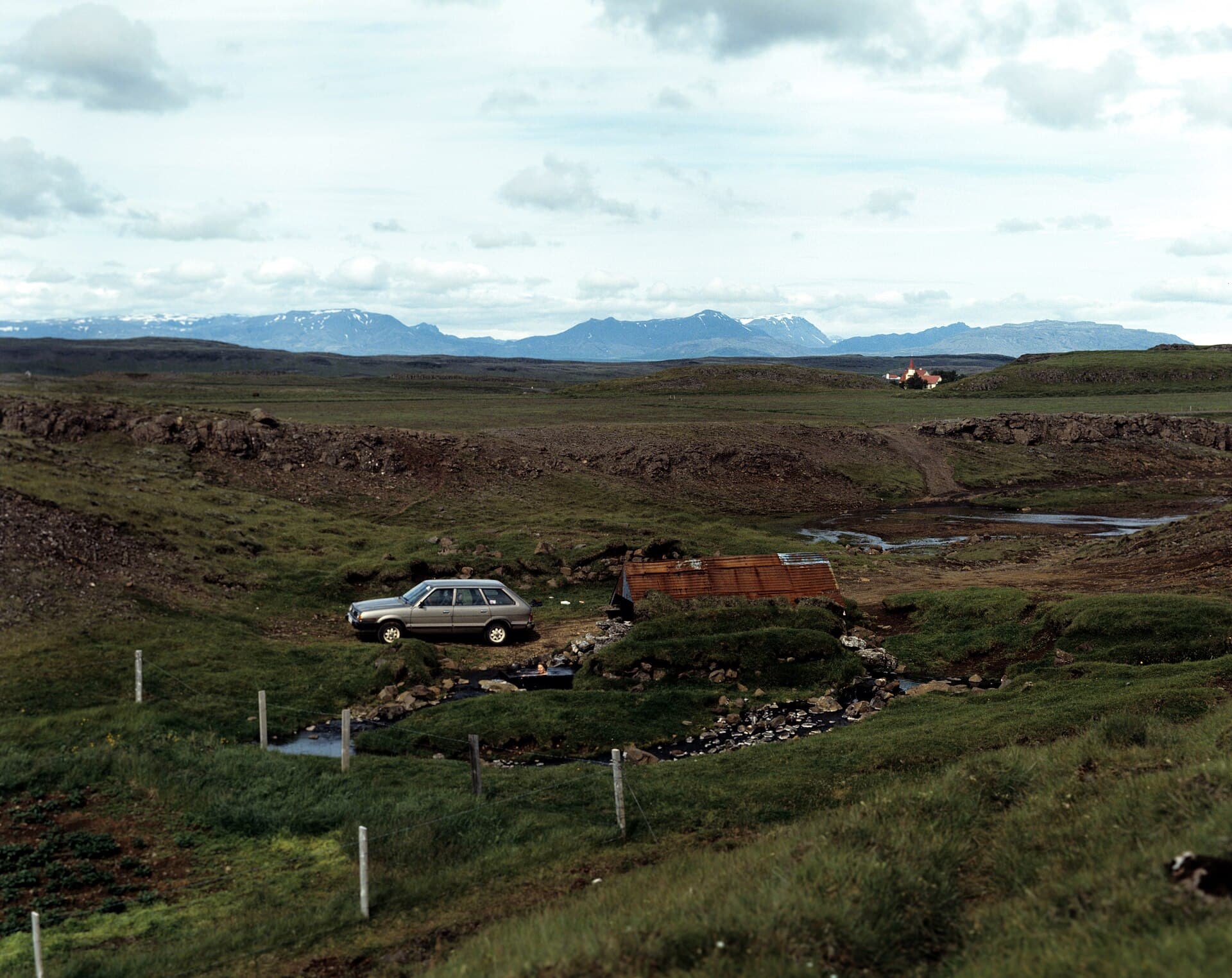 Steaming natural geothermal waters and historic bathhouse of the Secret Lagoon (Gamla Laugin) in Flúðir