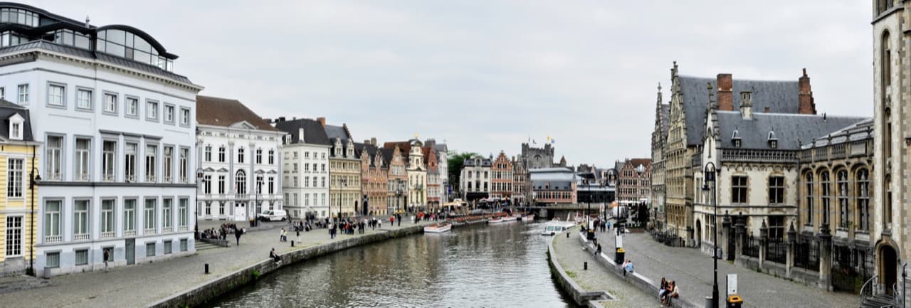 The medieval guild houses of the Graslei and Korenlei mirrored in the canal beneath Saint Michael's Bridge in Ghent