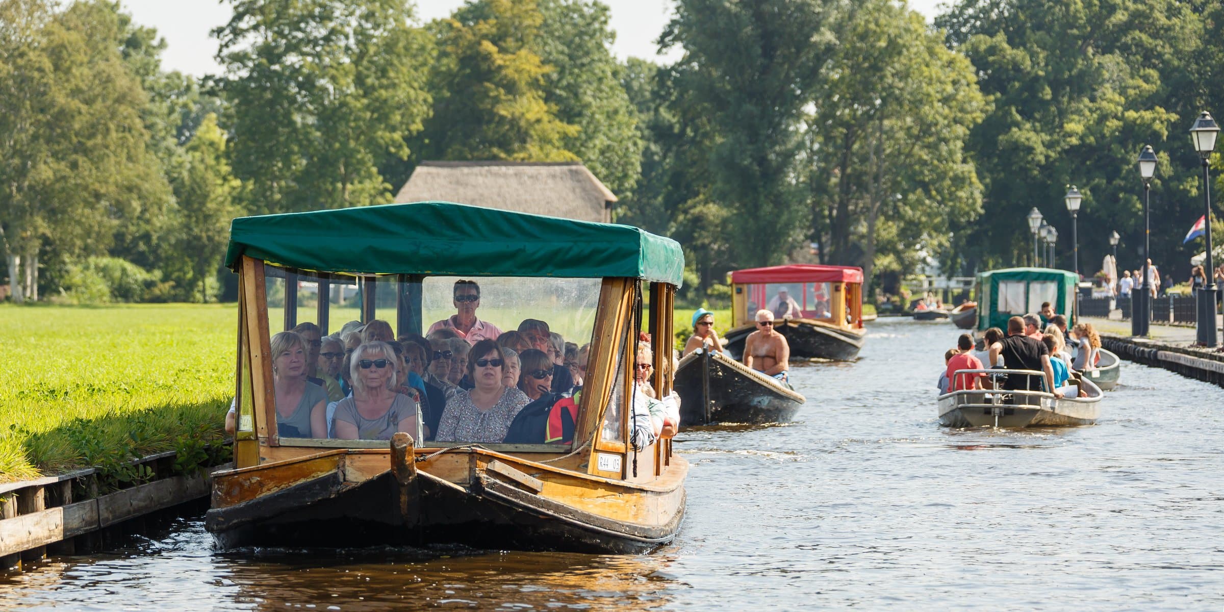 Thatched farmhouses, wooden footbridges and calm tree-lined canals in Giethoorn