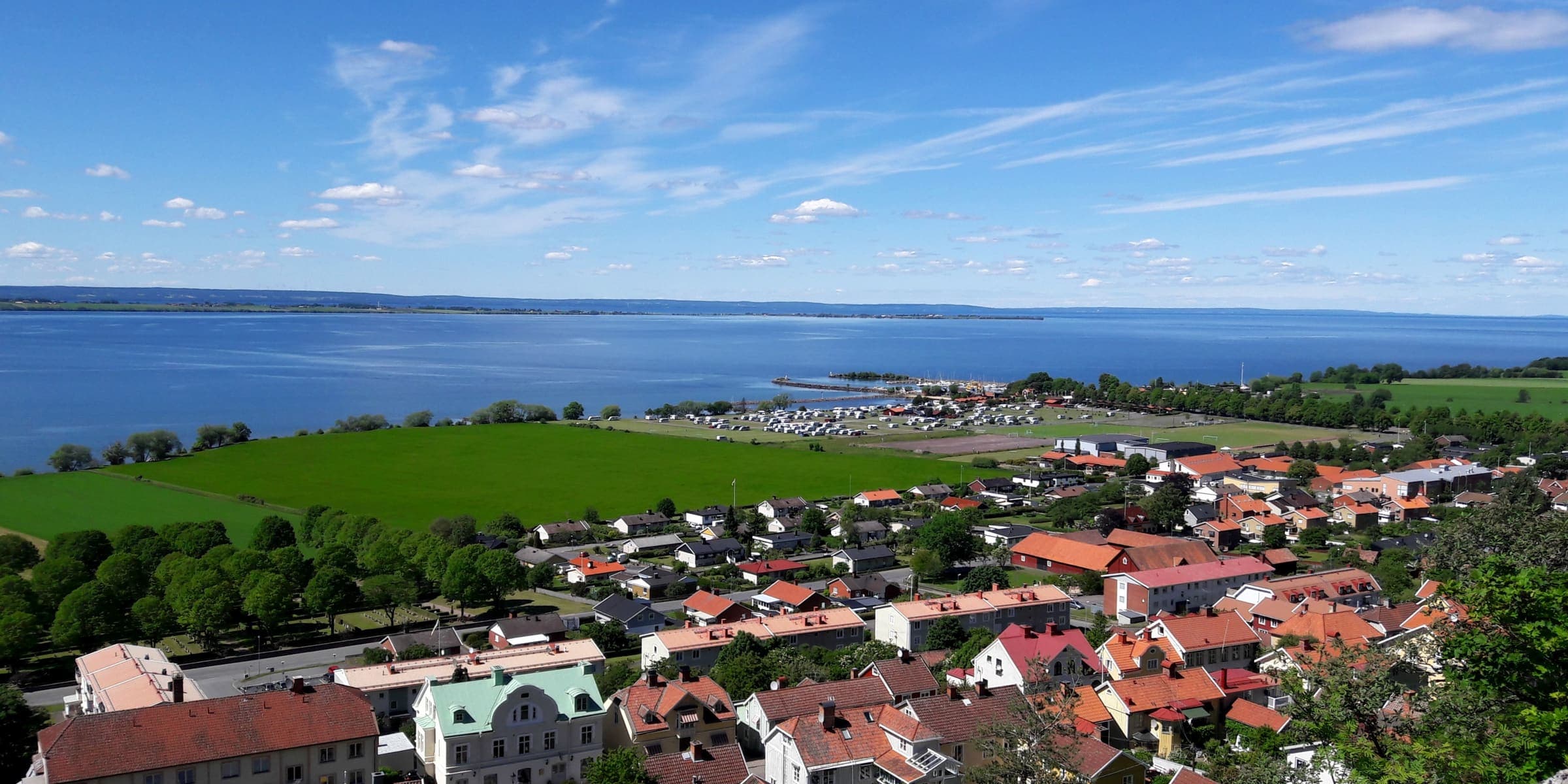 Gränna's red roofs from the hillside, with Lake Vättern and the island of Visingsö beyond