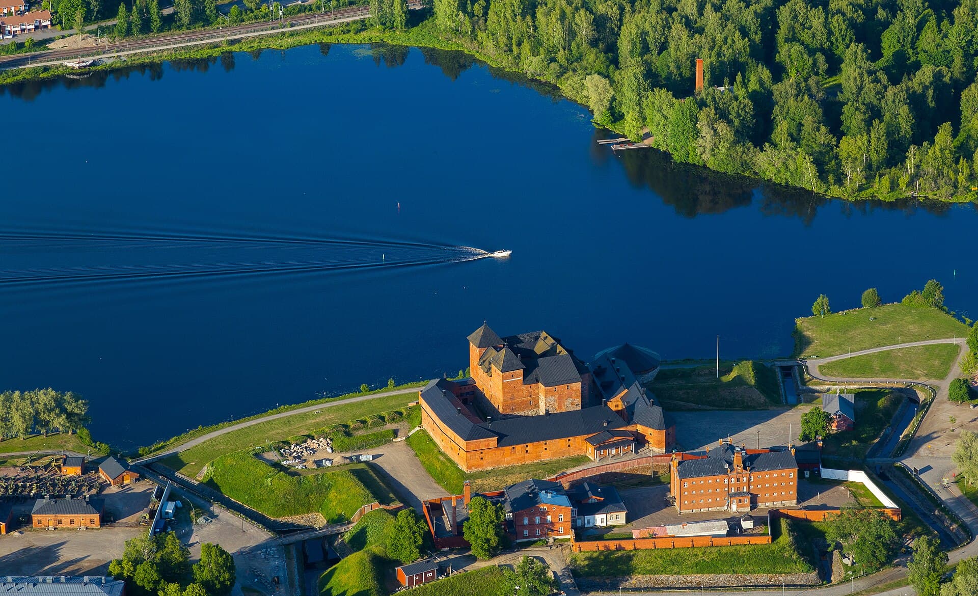Aerial view of medieval red-brick Häme Castle and the waters of Lake Vanajavesi in Hämeenlinna