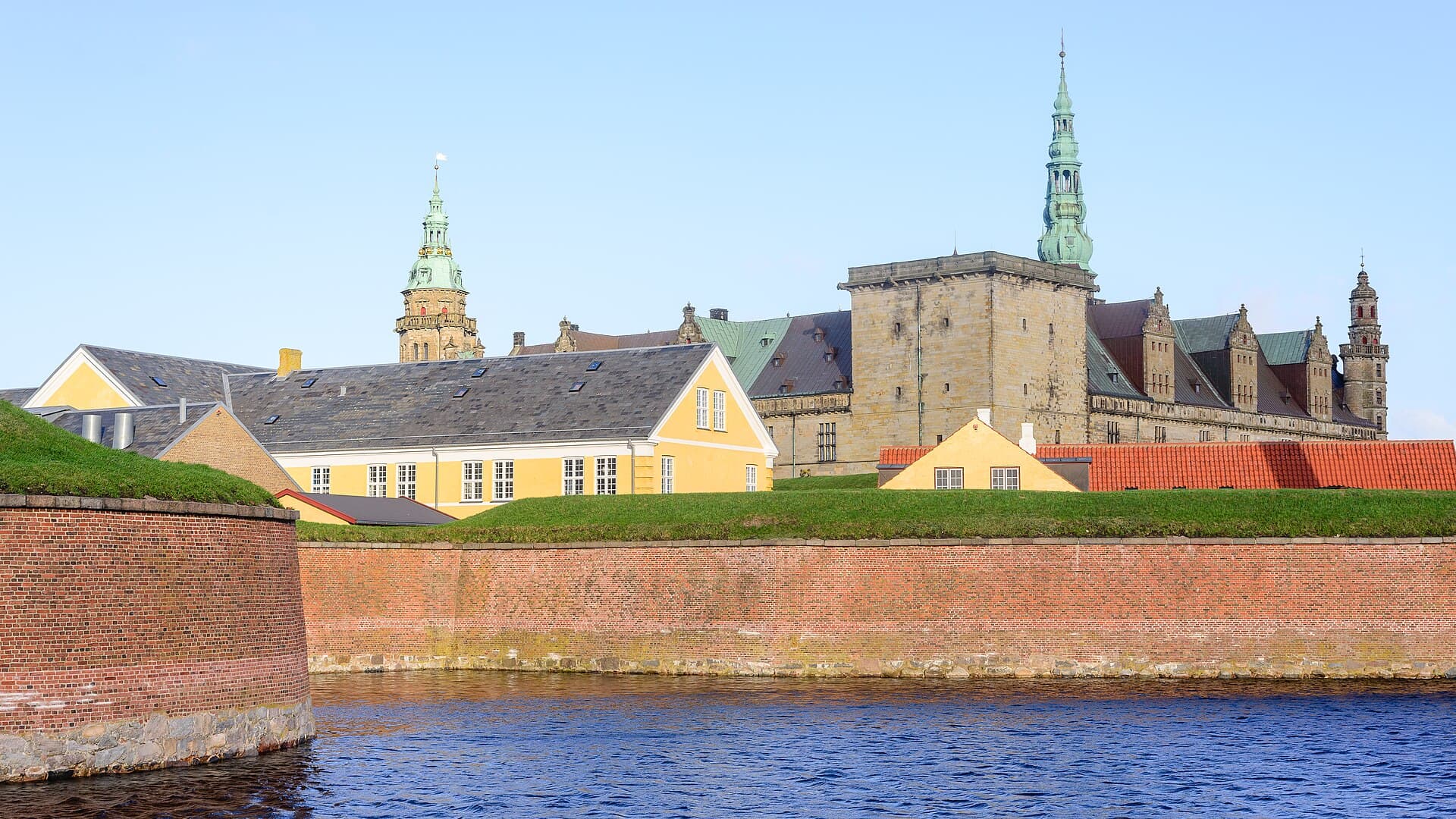 Turrets and moated sandstone ramparts of UNESCO-listed Kronborg Castle overlooking the Øresund strait in Helsingør.