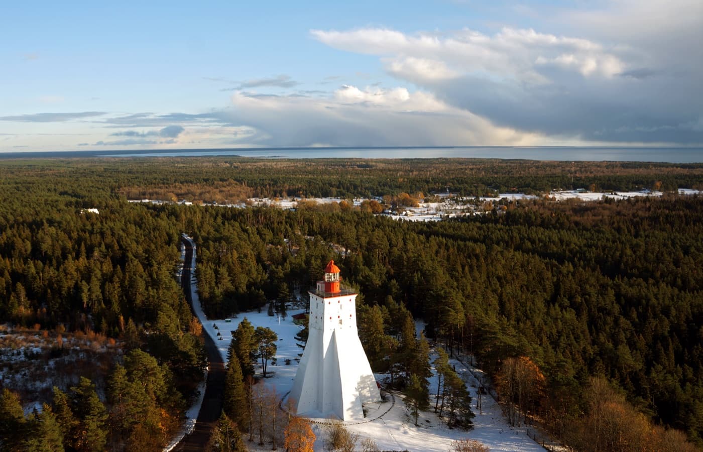 The ancient massive stone Kõpu Lighthouse perched on a forested hill above Hiiumaa island