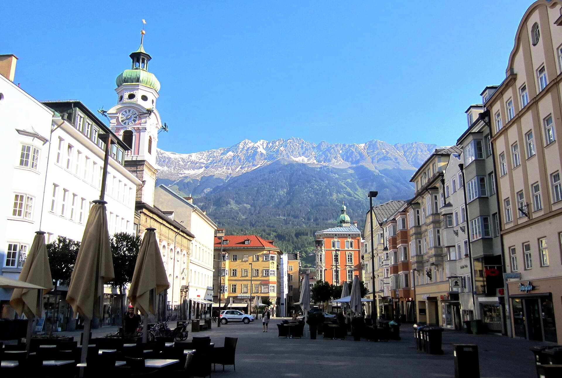 Maria-Theresien-Straße in Innsbruck with the jagged Nordkette mountain range rising directly behind