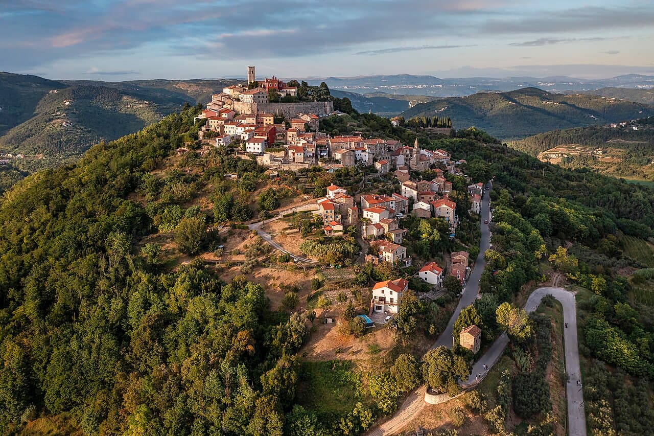 Aerial panorama of the fortified hilltop town of Motovun rising above Istrian vineyards