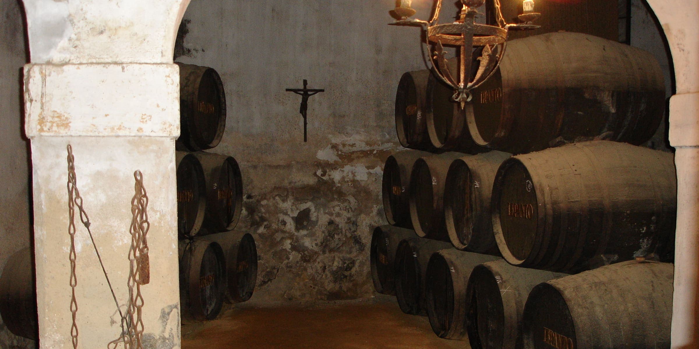 Stacked sherry casks in a whitewashed bodega in Jerez
