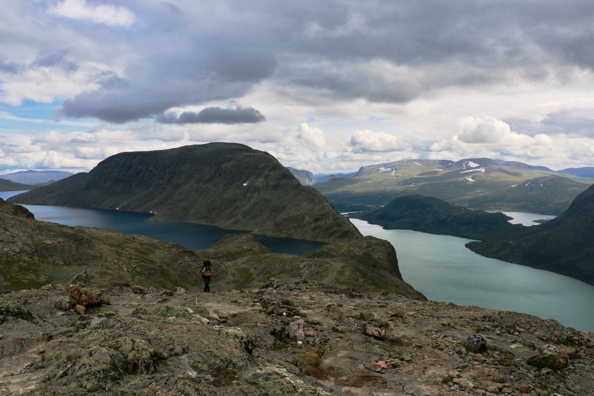 Narrow knife-edge rock ridge of Besseggen separating emerald Lake Gjende from deep blue Lake Bessvatnet in Jotunheimen
