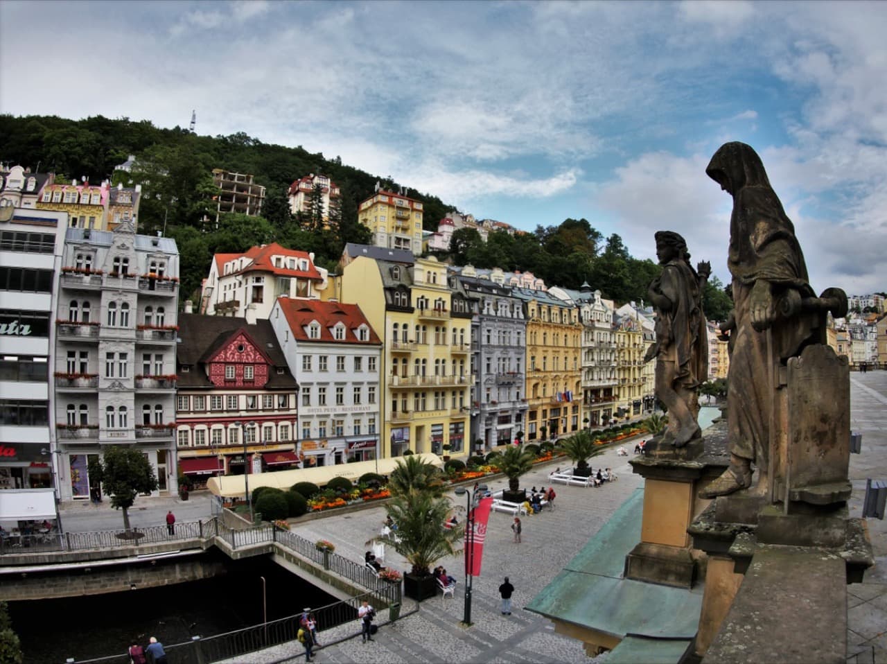 Grand pastel spa colonnades lining the Teplá River promenade in Karlovy Vary