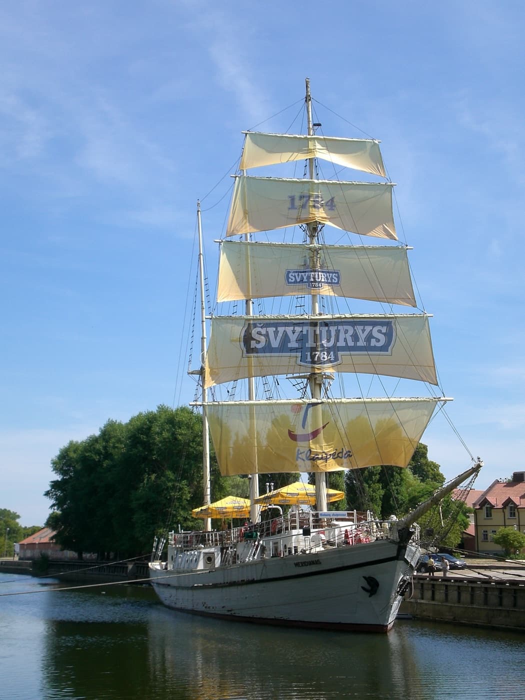 The historic wooden sailing ship Meridianas moored on the Danė River in Klaipėda Old Town