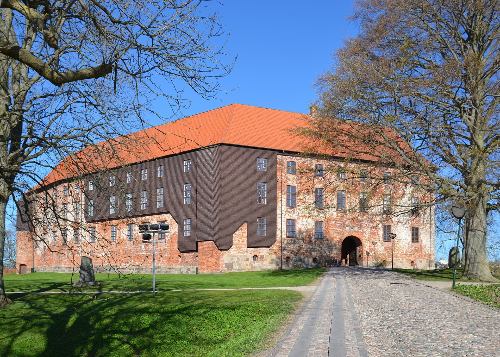 The imposing stone towers and lake reflection of Koldinghus royal castle in Kolding.