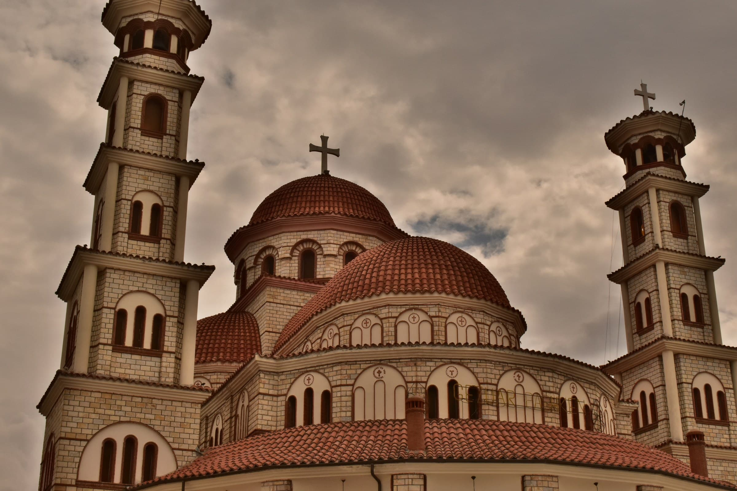 The twin domes and stone colonnade of the Resurrection of Christ Orthodox Cathedral in Korçë