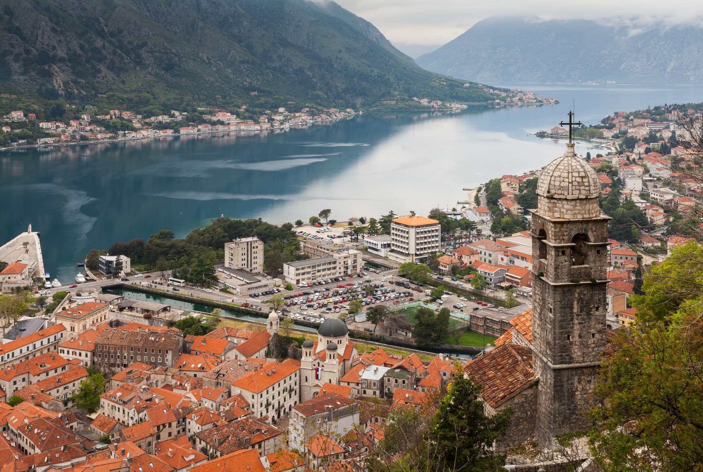 Church of Our Lady of Remedy and stone terracotta roofs of Kotor with the fjord-like bay beyond