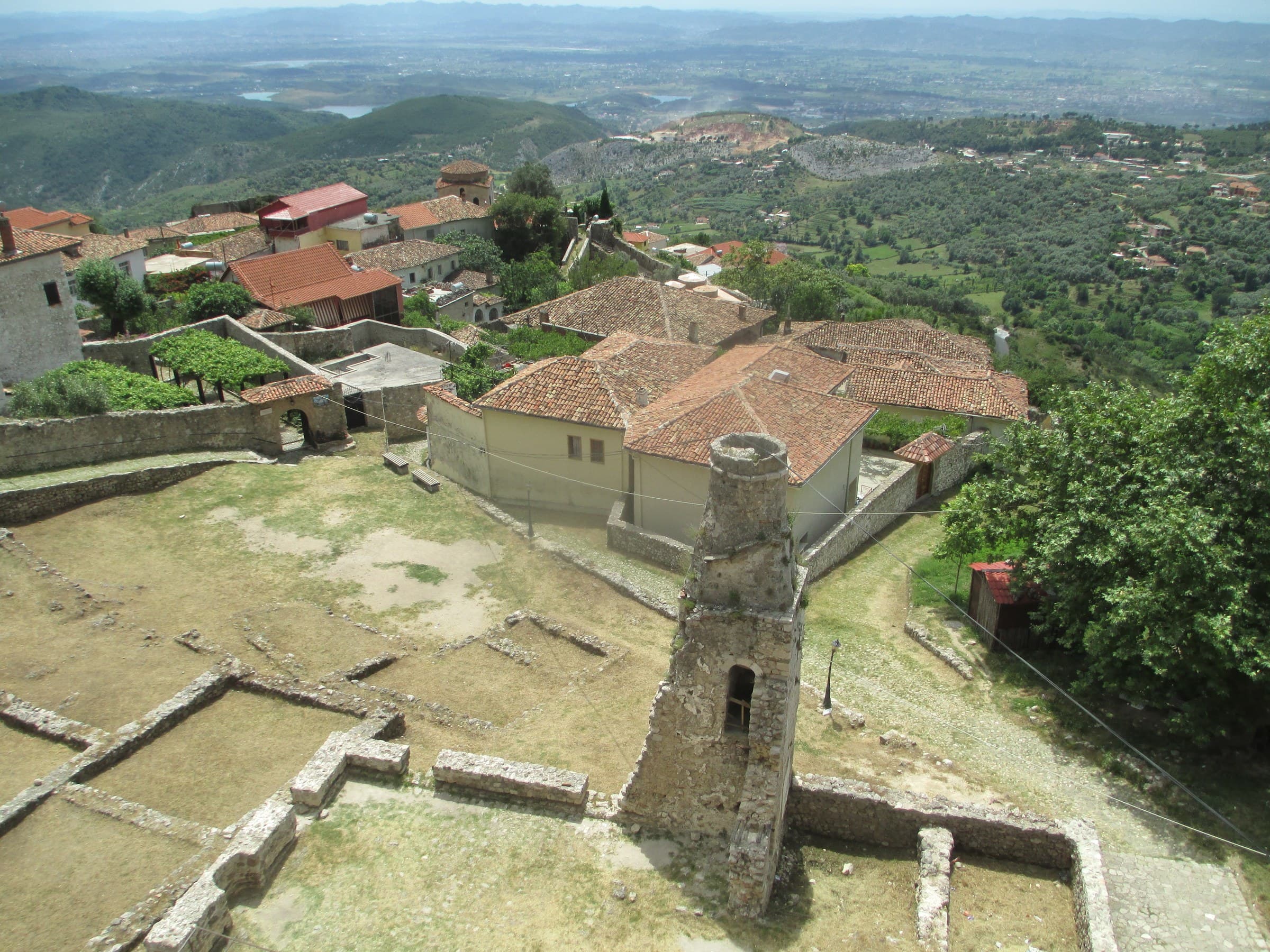 The stone ramparts and mountain mosque minaret of Krujë Castle overlooking the coastal plain