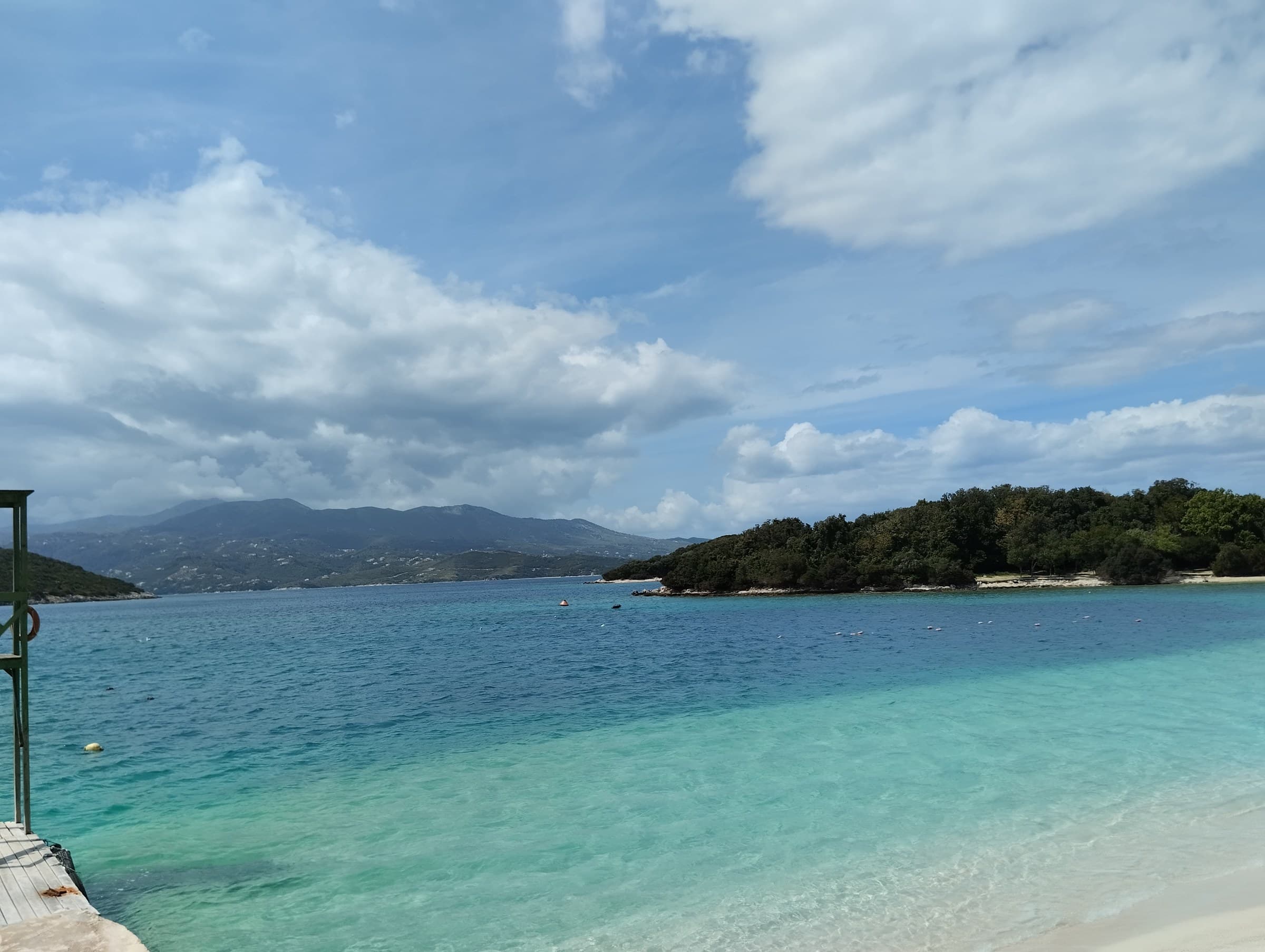 Crystal turquoise waters and white sand coves looking out to the four small green Ksamil Islands