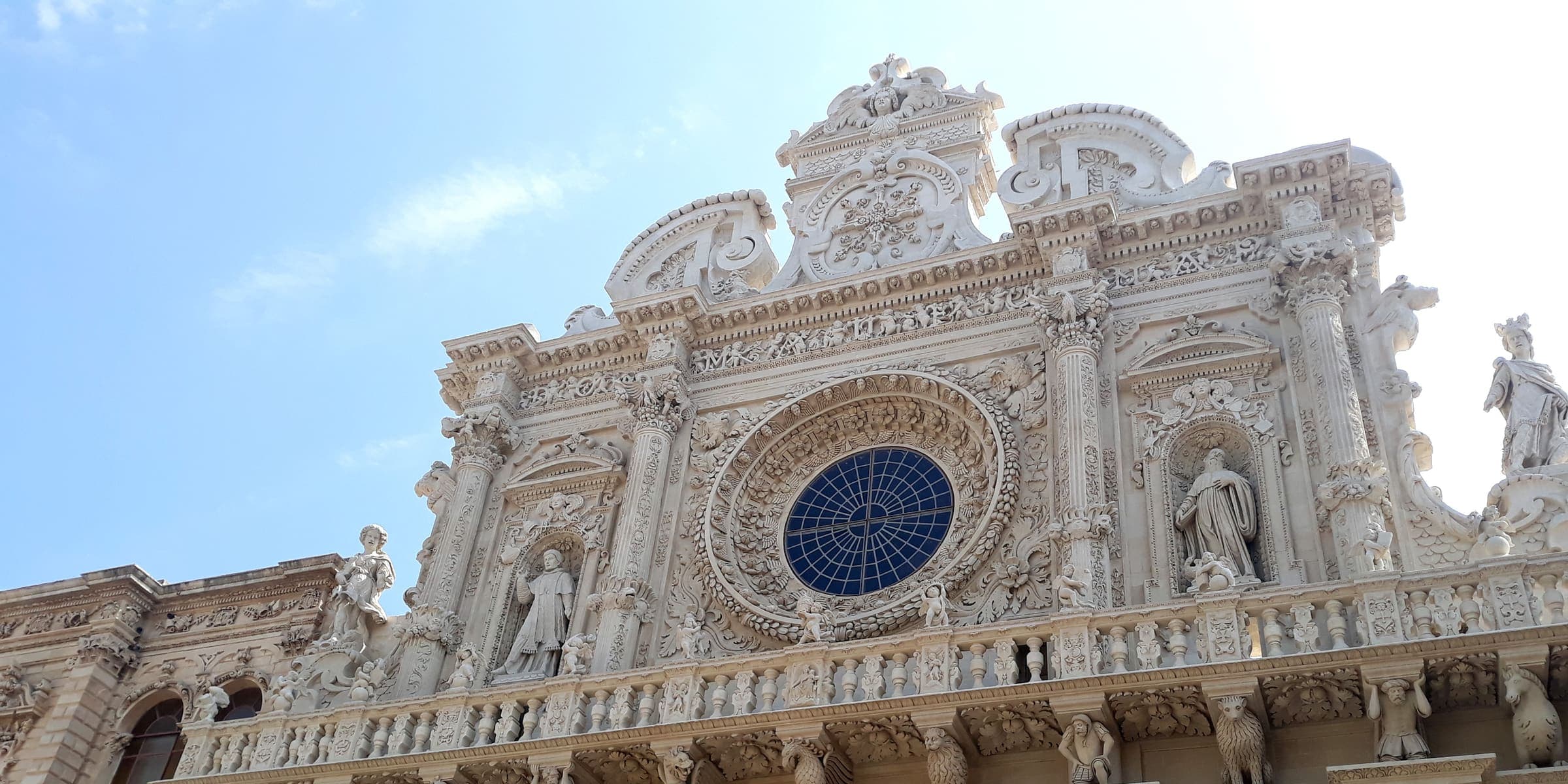The carved baroque façade and rose window of the Basilica of Santa Croce in Lecce
