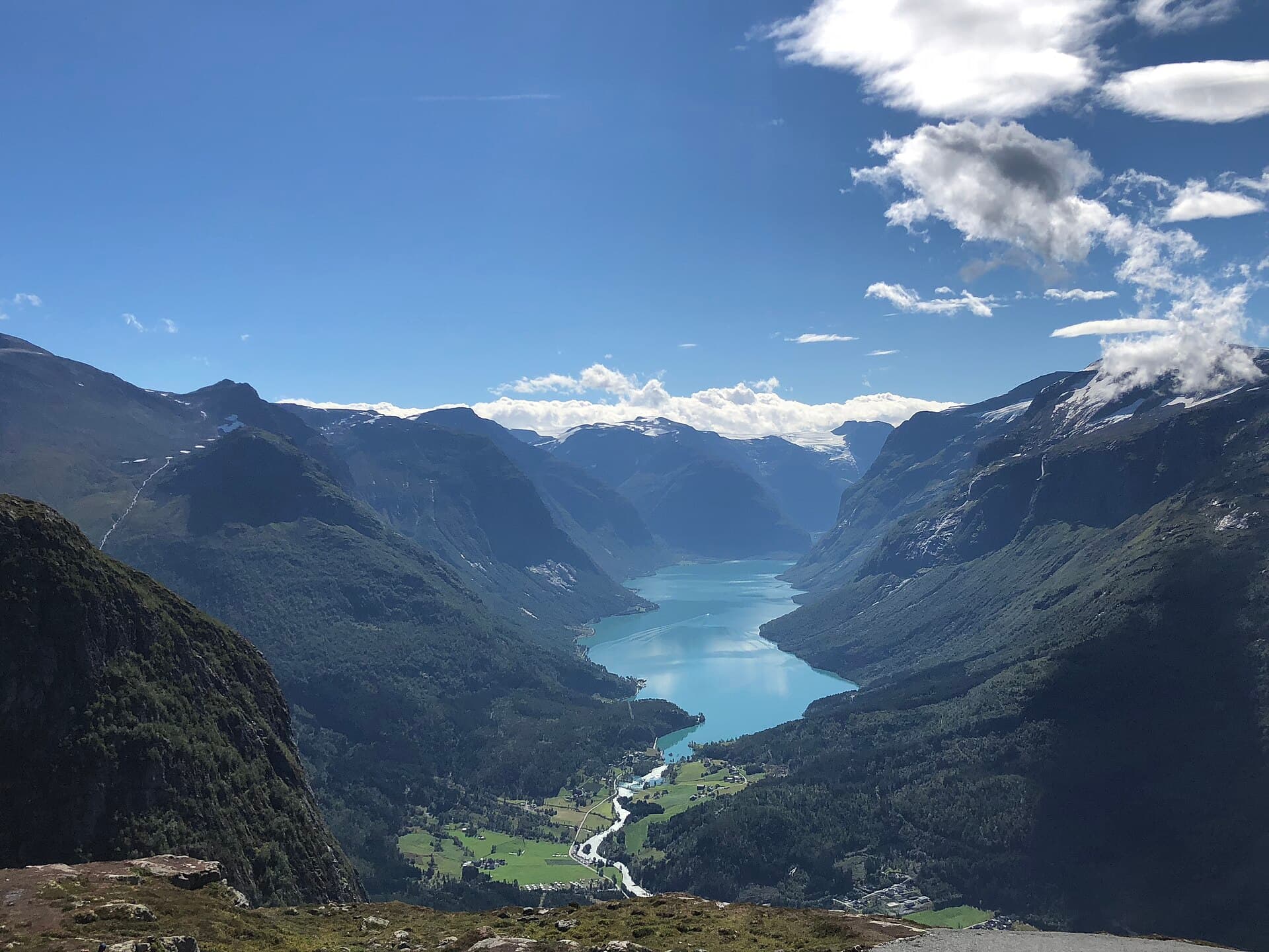Turquoise waters of Lake Lovatnet surrounded by steep glacial peaks in Loen, Nordfjord.