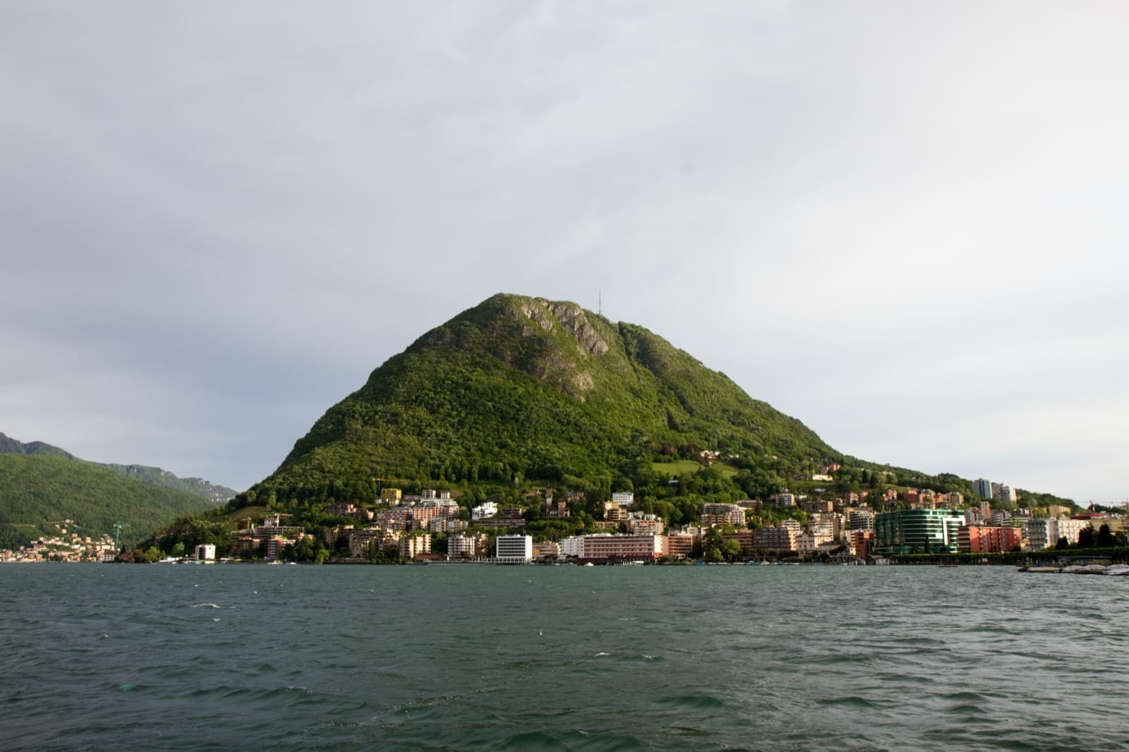Monte San Salvatore rising above the sparkling blue waters of Lake Lugano