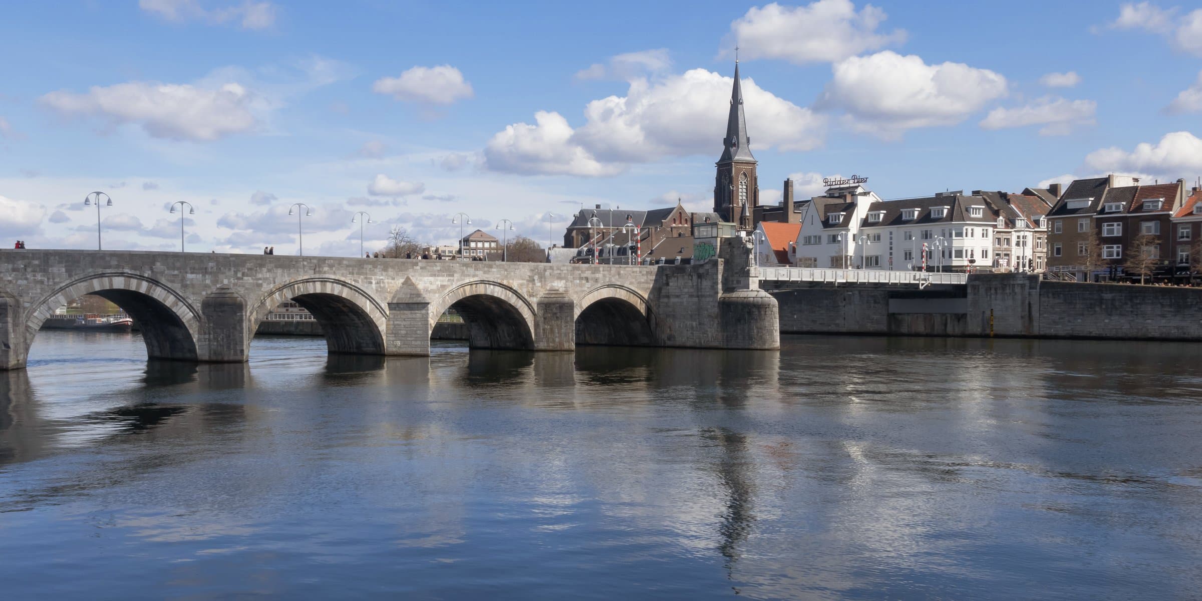 The 13th-century arched stone Sint Servaasbrug crossing the river Meuse into historic Maastricht