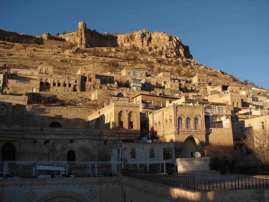 Honey-coloured stone carved terraces of Mardin old town overlooking the vast Mesopotamian plains