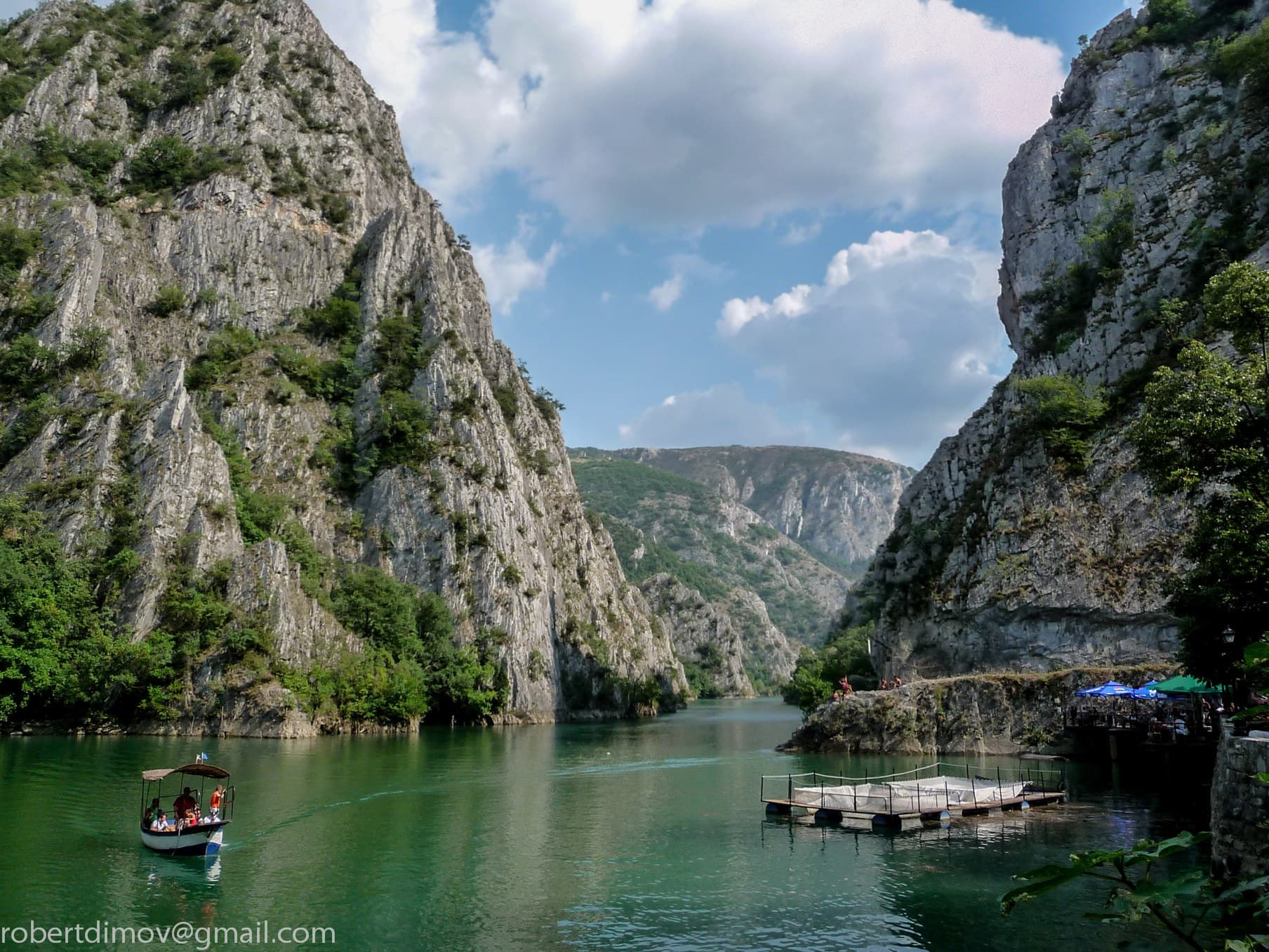 Still green water of Lake Matka between the steep limestone walls of the Treska canyon