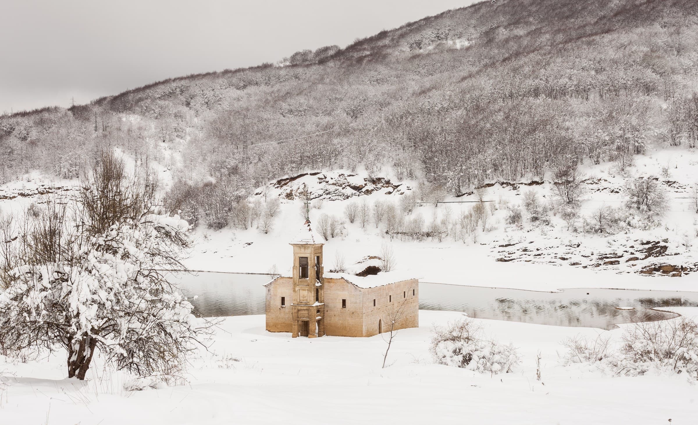 The half-submerged church of Saint Nicholas standing in the shallows of Lake Mavrovo