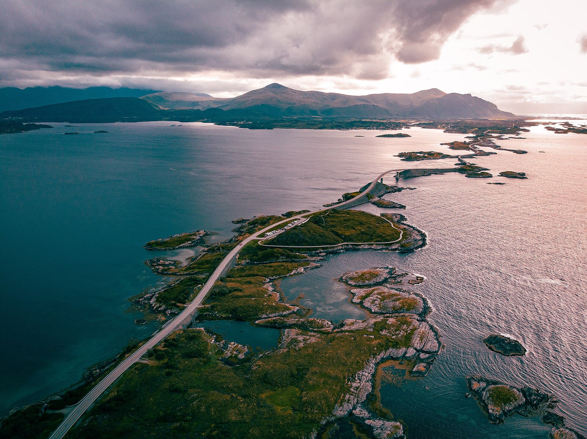 Storseisundet Bridge curving dramatically over Atlantic breakers along the Atlantic Ocean Road.