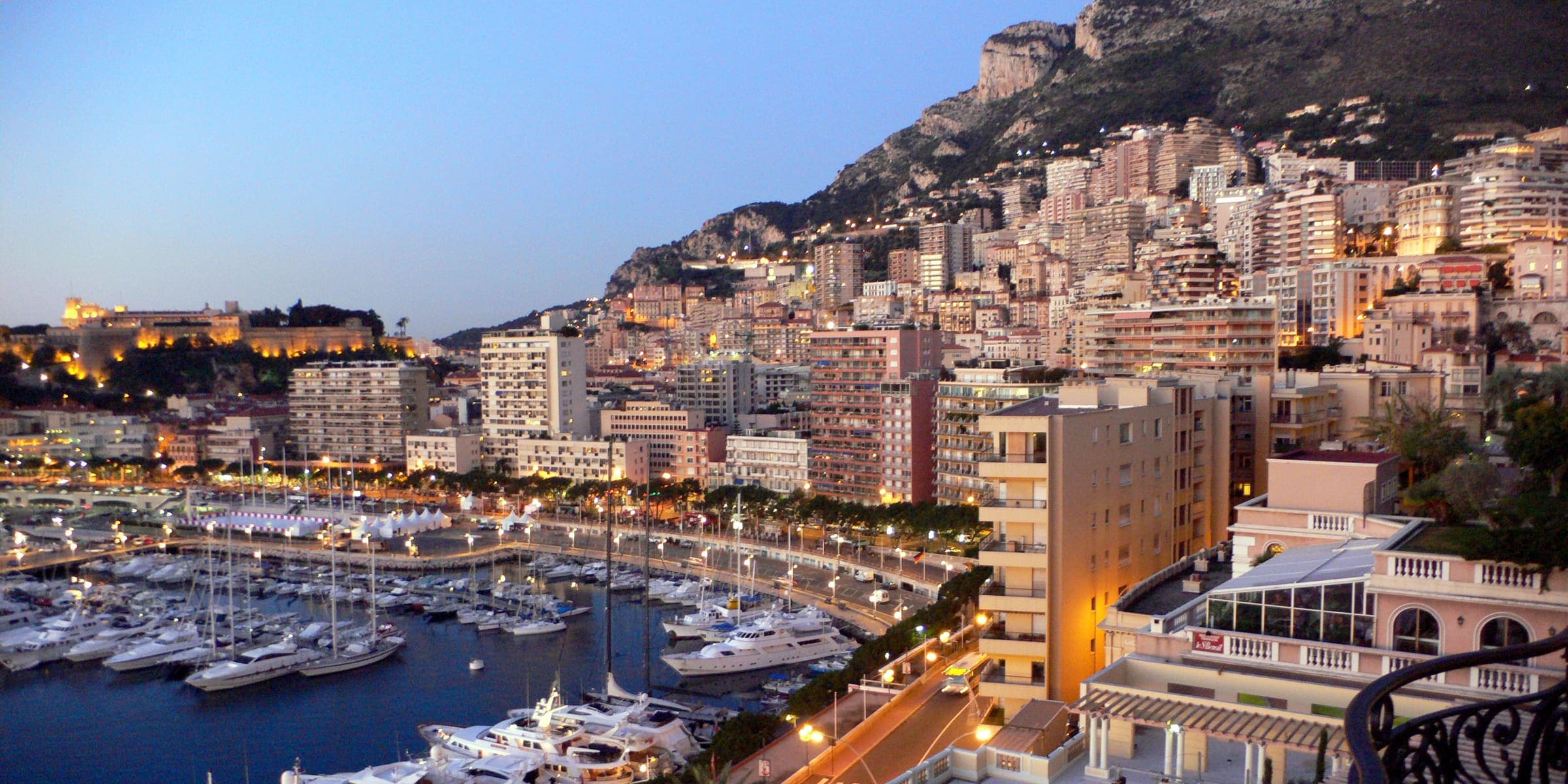 Port Hercule and the towers of Monte Carlo rising up the hillside at dusk