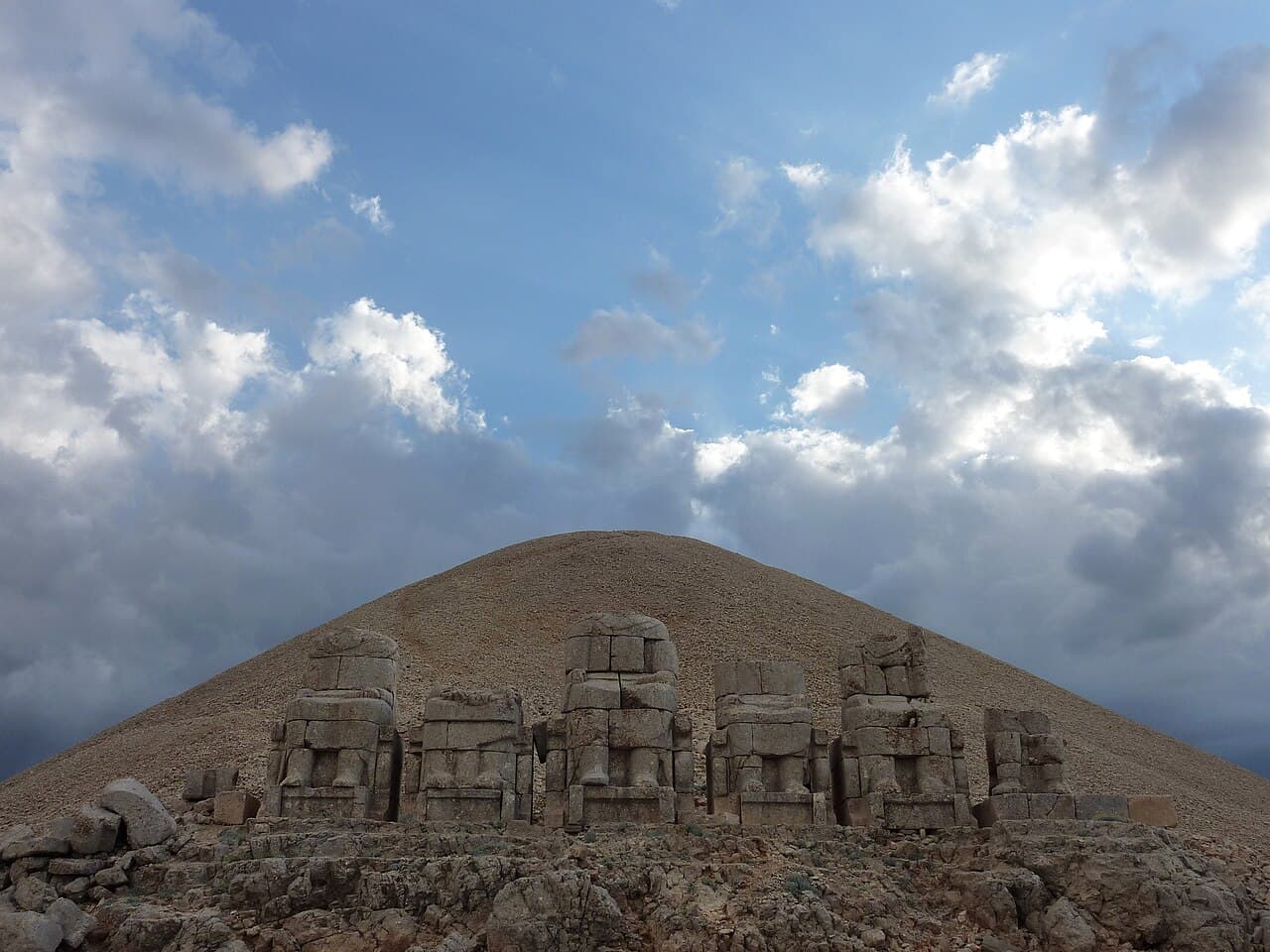 Colossal stone heads of gods and King Antiochus I resting on the eastern terrace of Mount Nemrut at sunrise