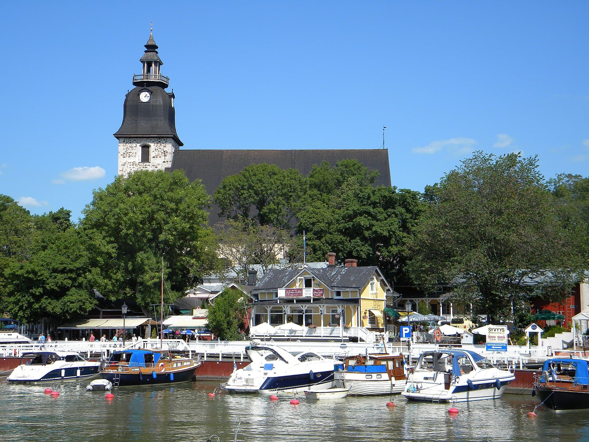 Picturesque wooden harbour waterfront and medieval stone convent church of Naantali
