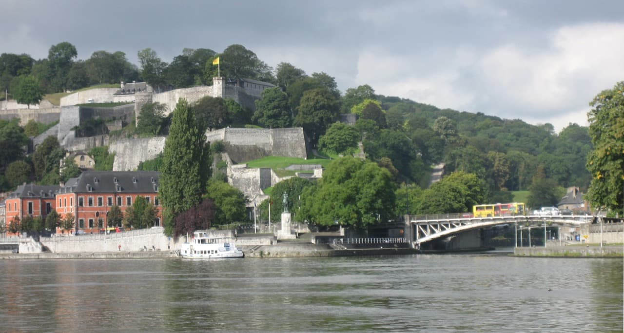 The Citadel of Namur rising high above the confluence of the Sambre and Meuse rivers and the Walloon Parliament