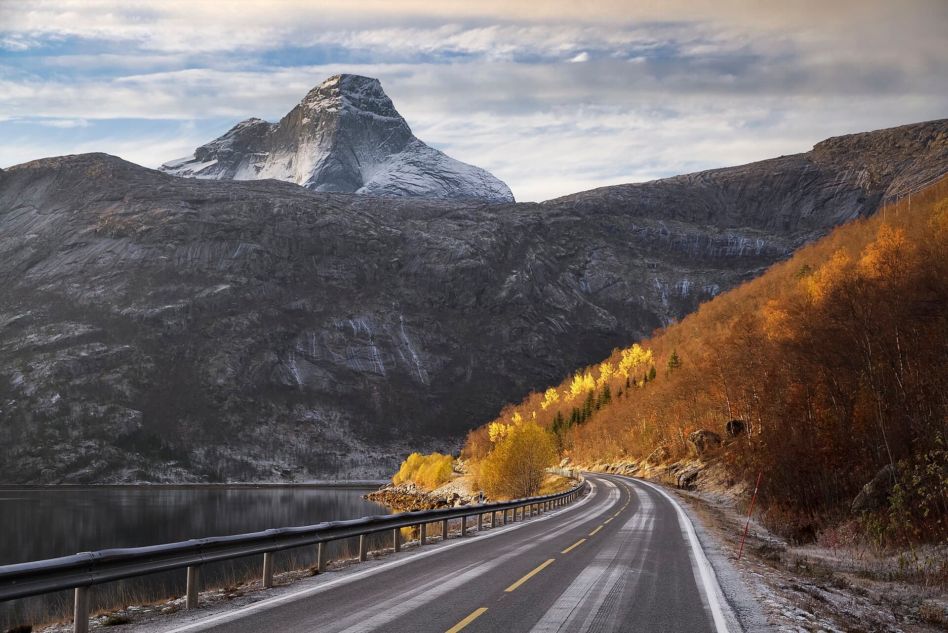 Road approaching the colossal granite obelisk of Stetind, Norway's national mountain, in Ofoten.
