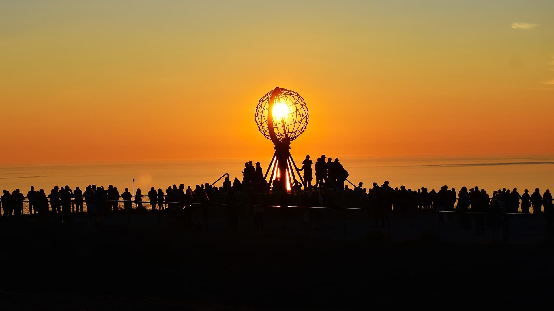 Midnight sun over the Globe Monument on the North Cape cliff plateau in Finnmark.