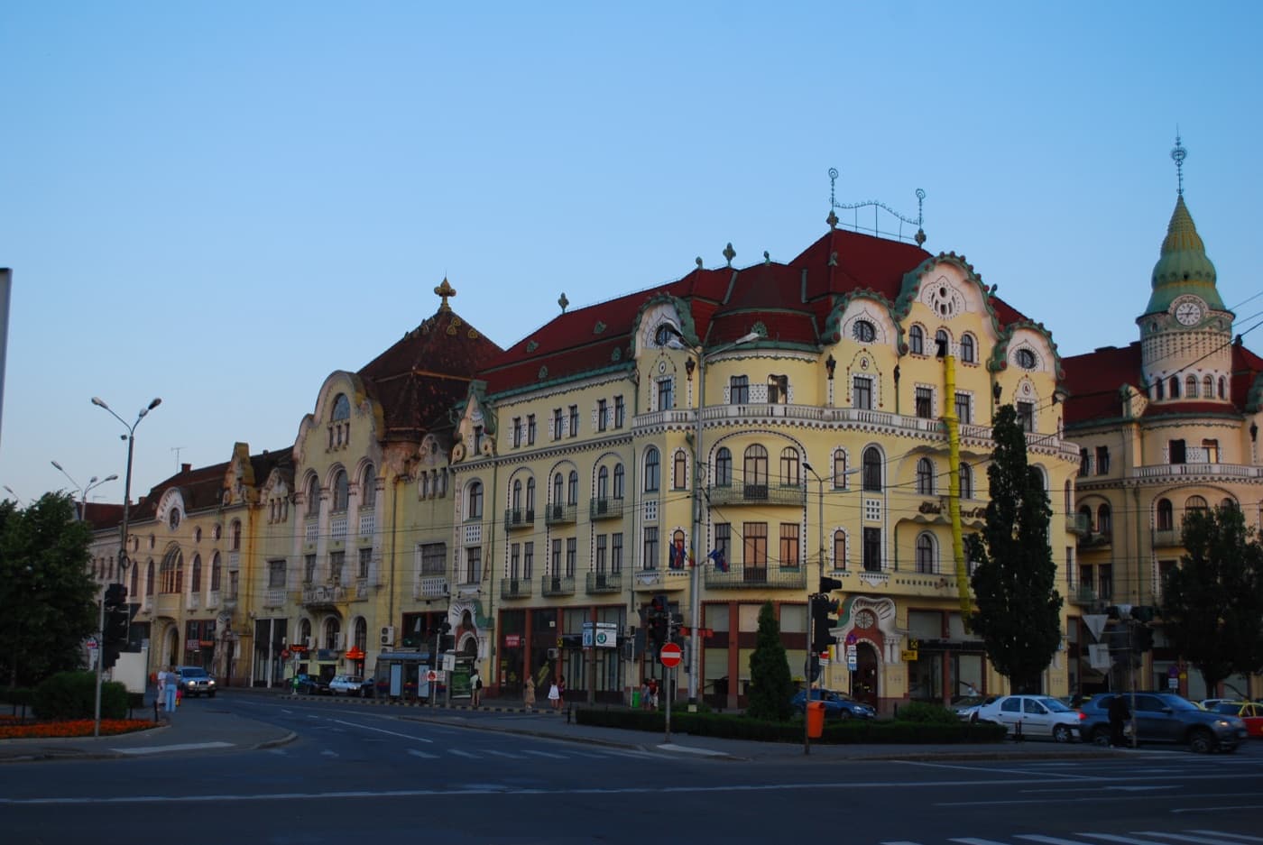 The ornate stained glass and curved facades of the Black Eagle Palace arcade in Oradea