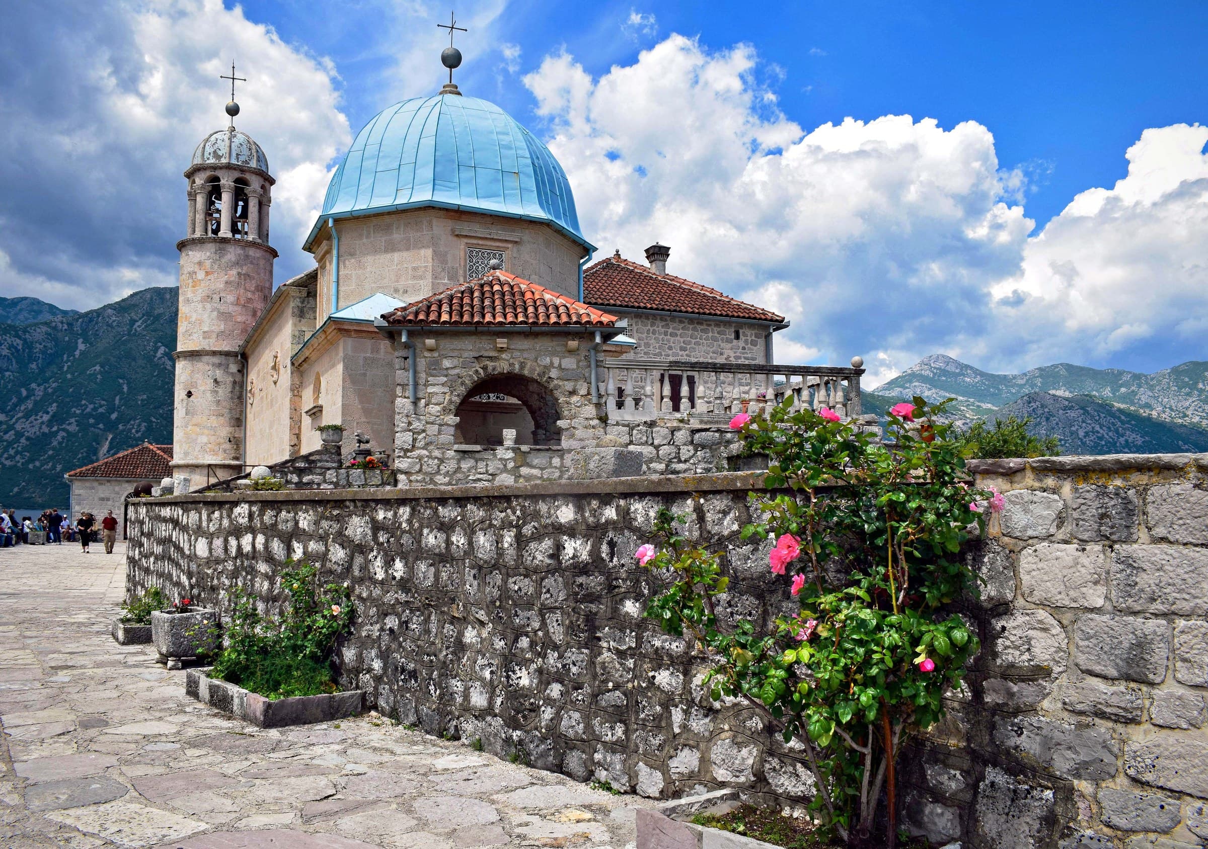 The island church of Our Lady of the Rocks resting on tranquil Boka Bay waters near Perast