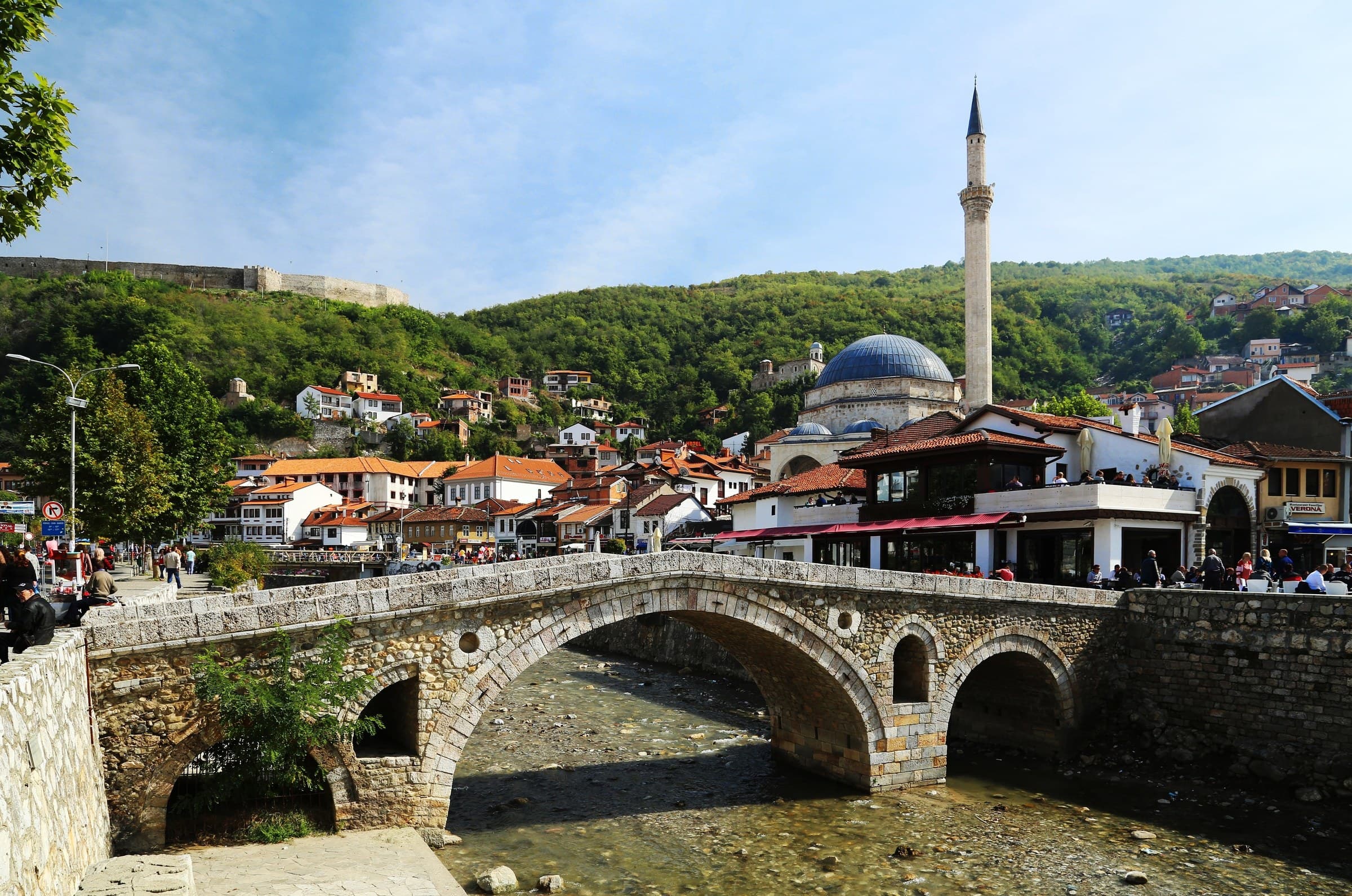 The dome and minaret of Sinan Pasha Mosque above the river and tiled roofs of Prizren