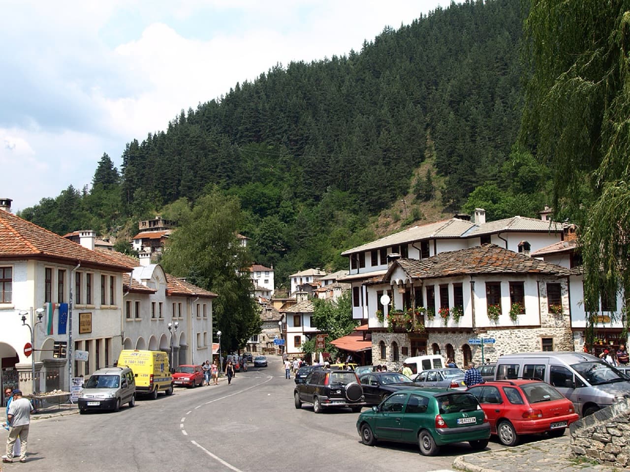 The traditional stone-and-timber Revival houses and arched bridge of Shiroka Laka in the Rhodope Mountains