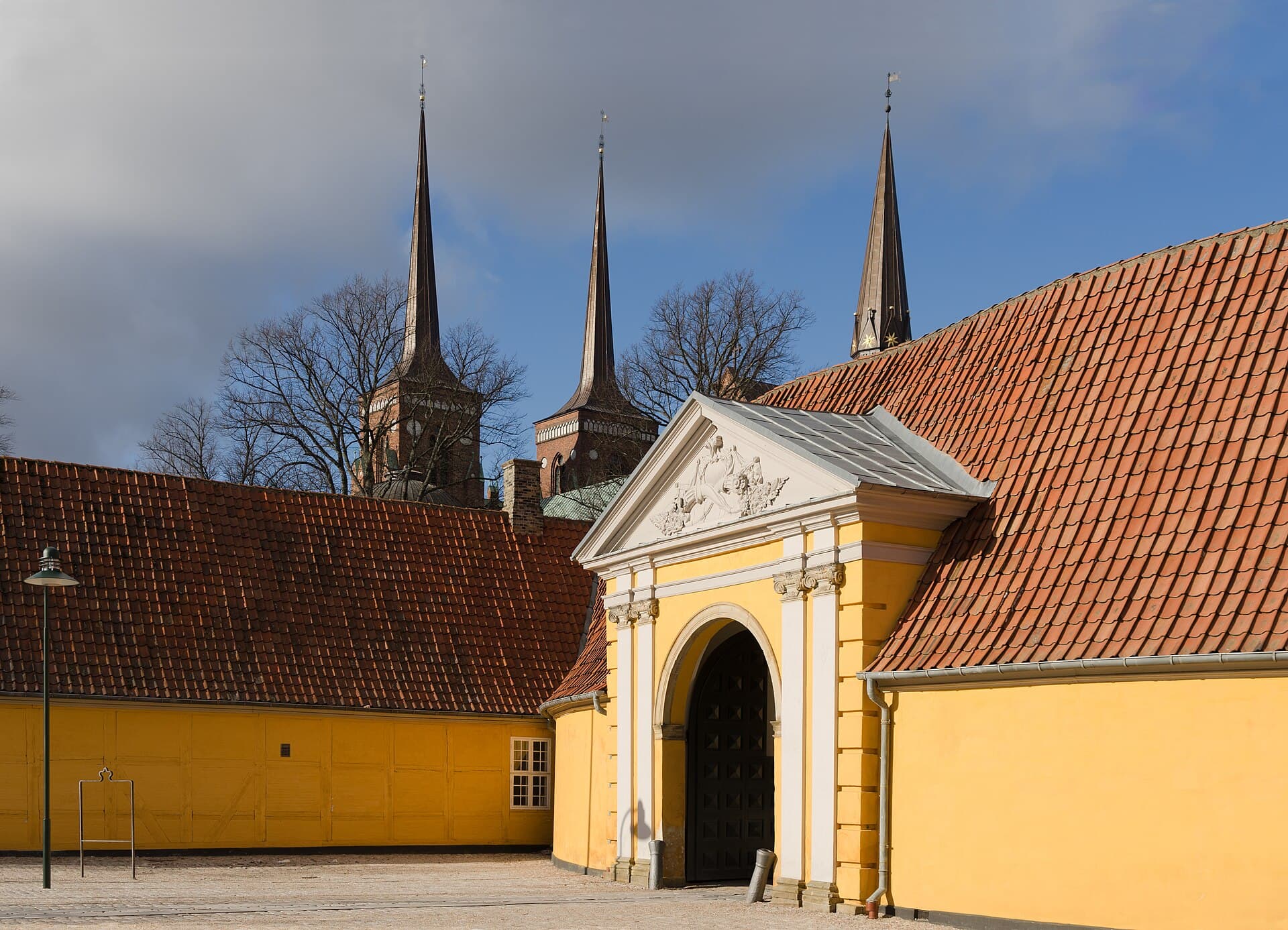 Twin brick spires of UNESCO-listed Roskilde Cathedral rising above the historic royal town.